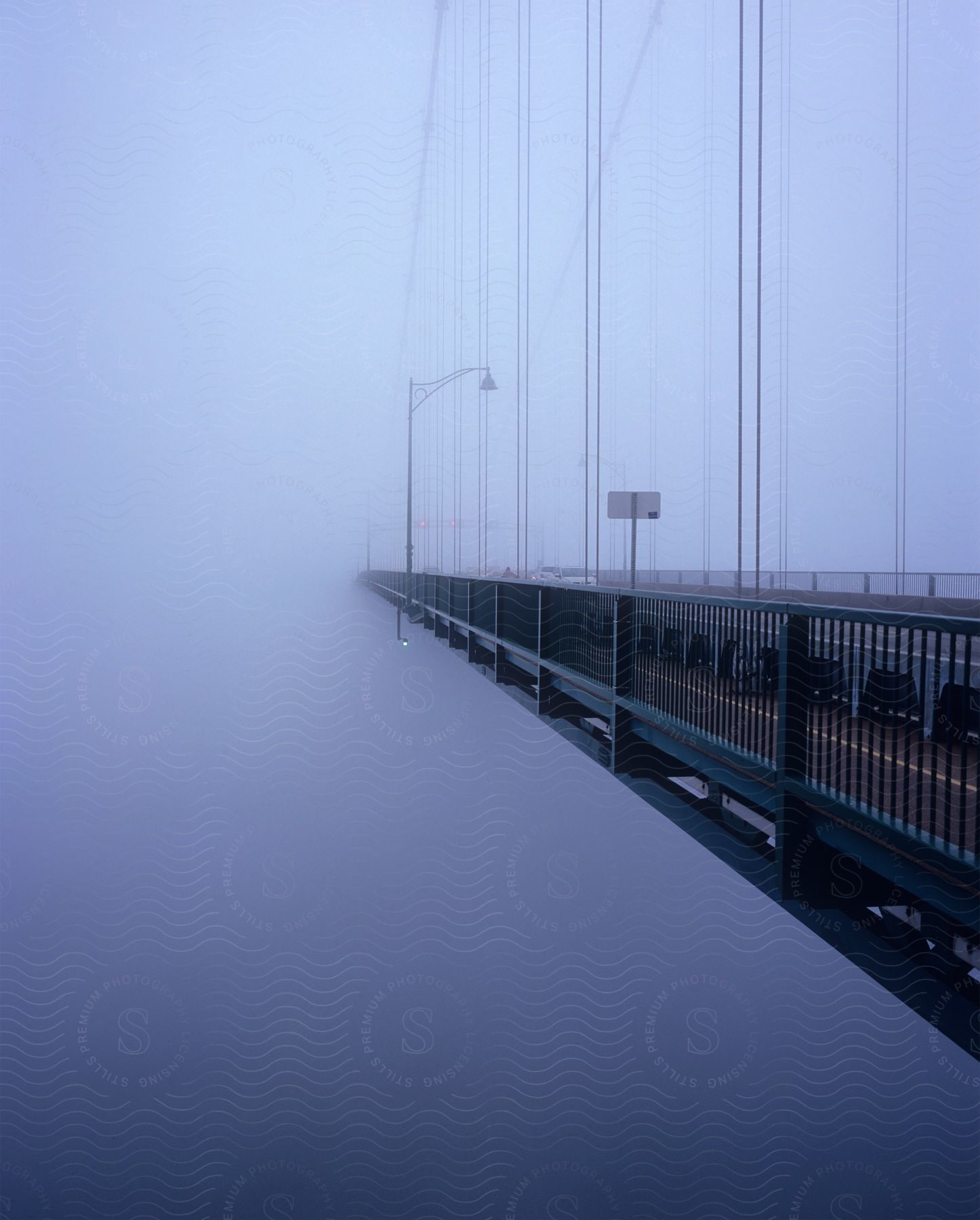 A bridge in foggy weather with an outdoor view