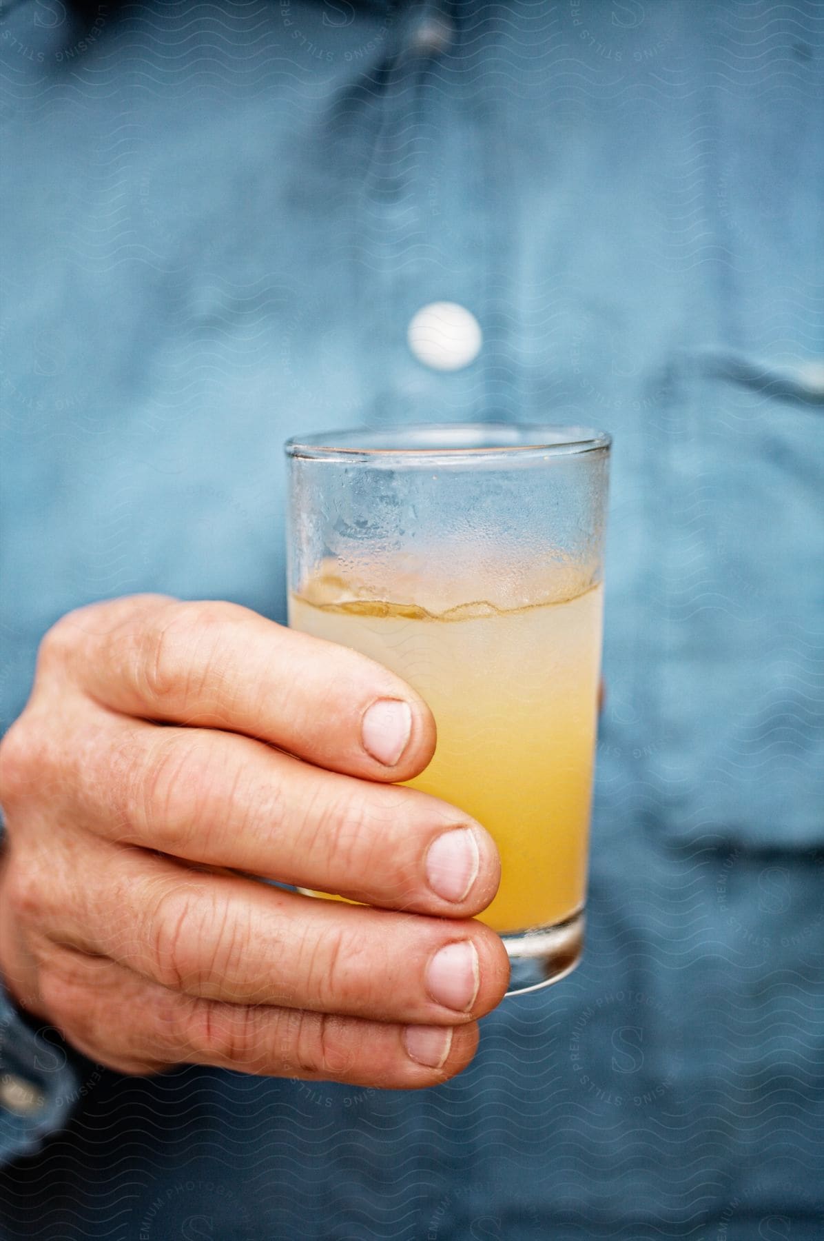 Male hands holding a beverage