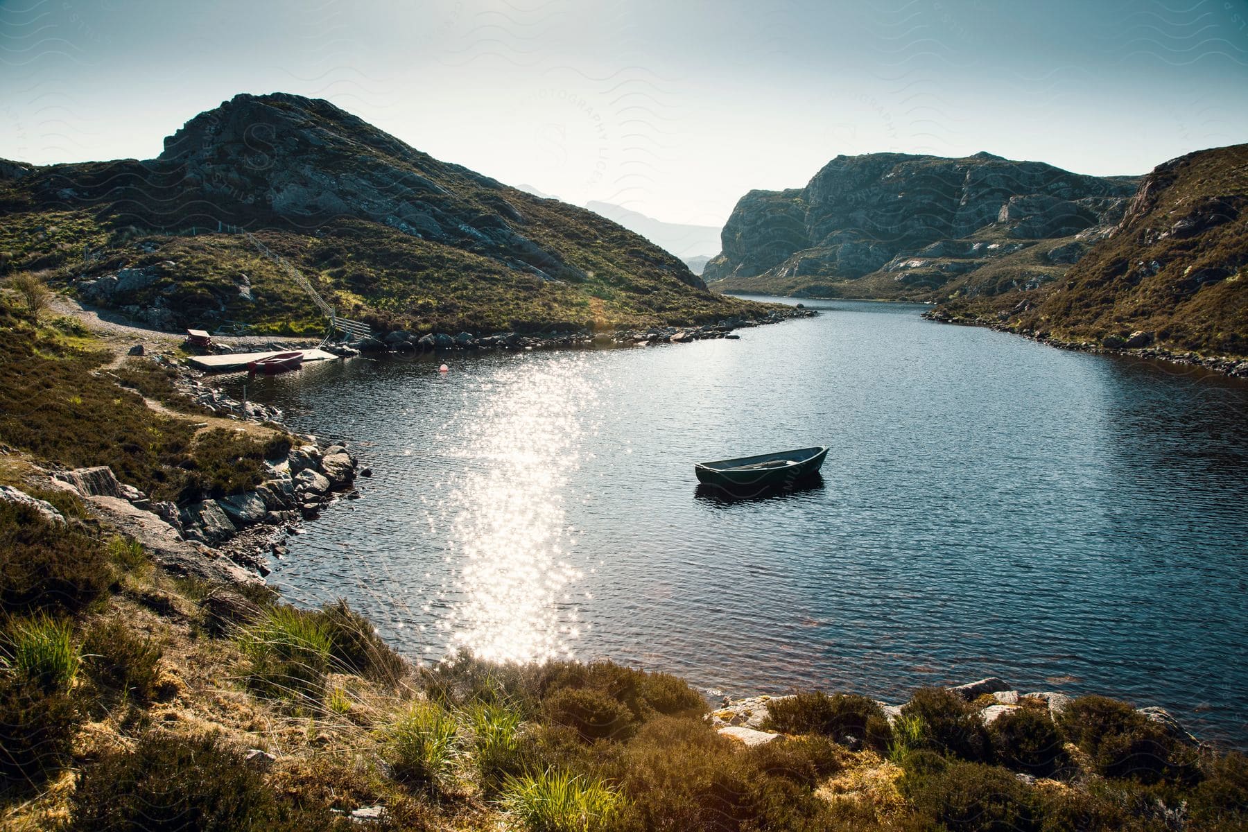 An empty canoe sits in the middle of a lake