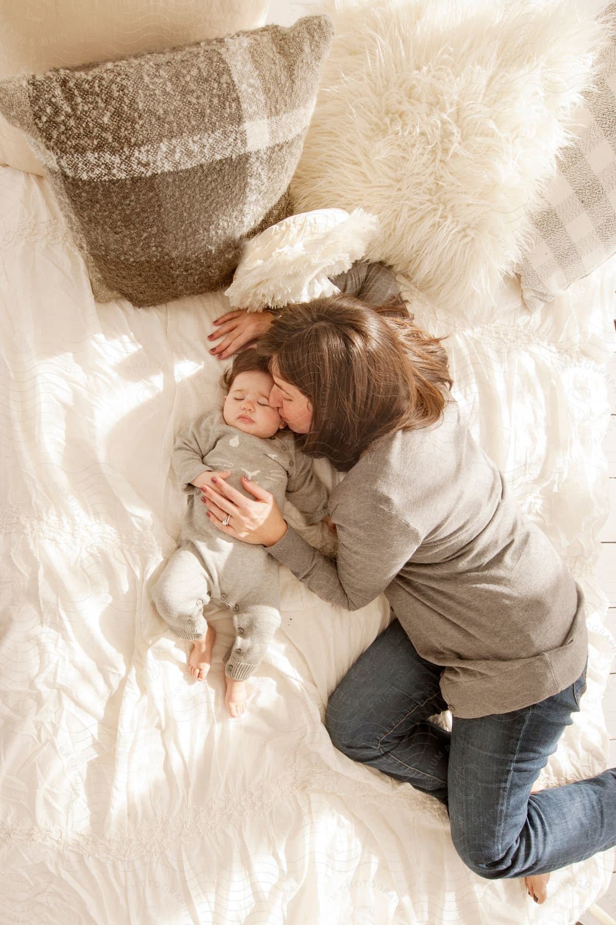 A mother and child sleeping together in a bed