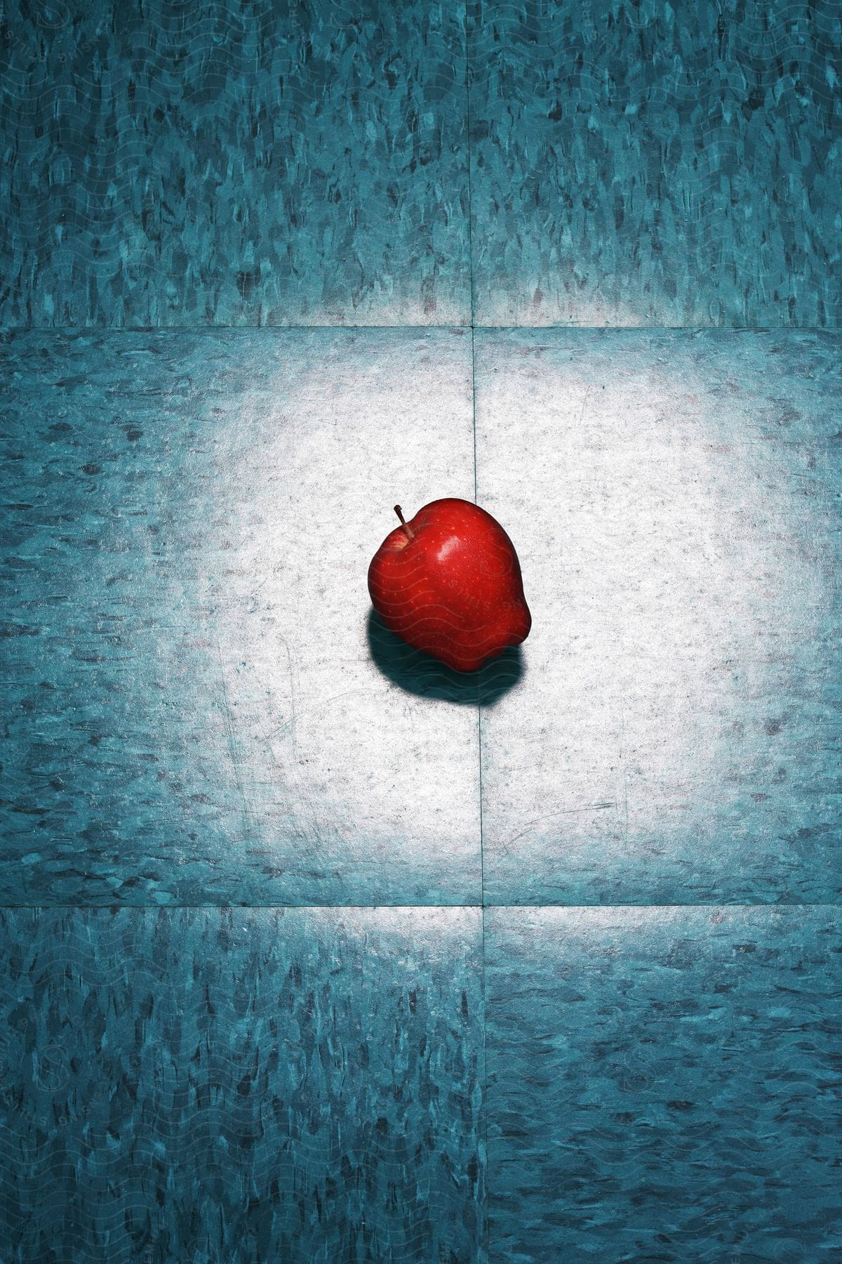 A red apple on the floor