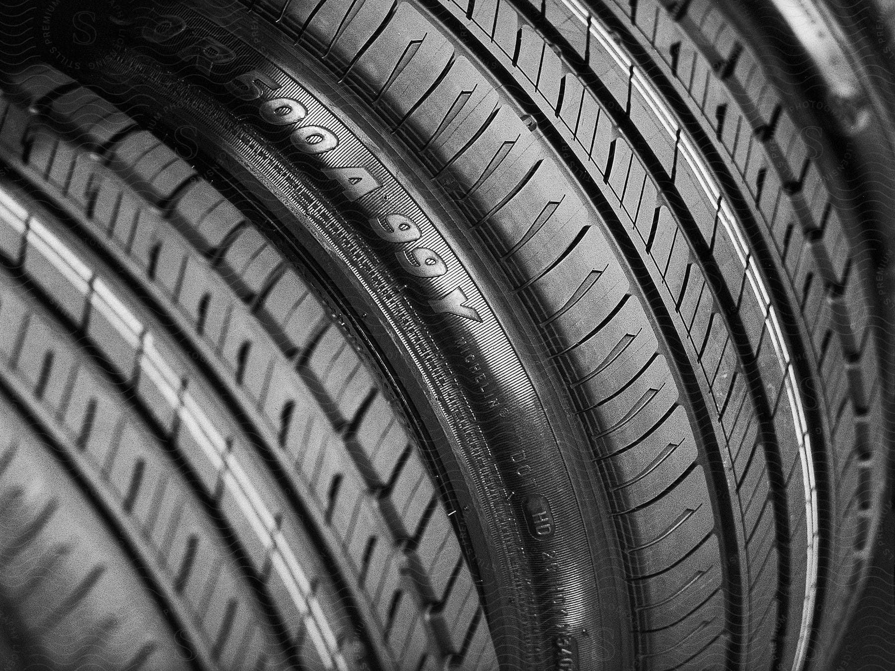 Close up of two car tires showing the tire sipes