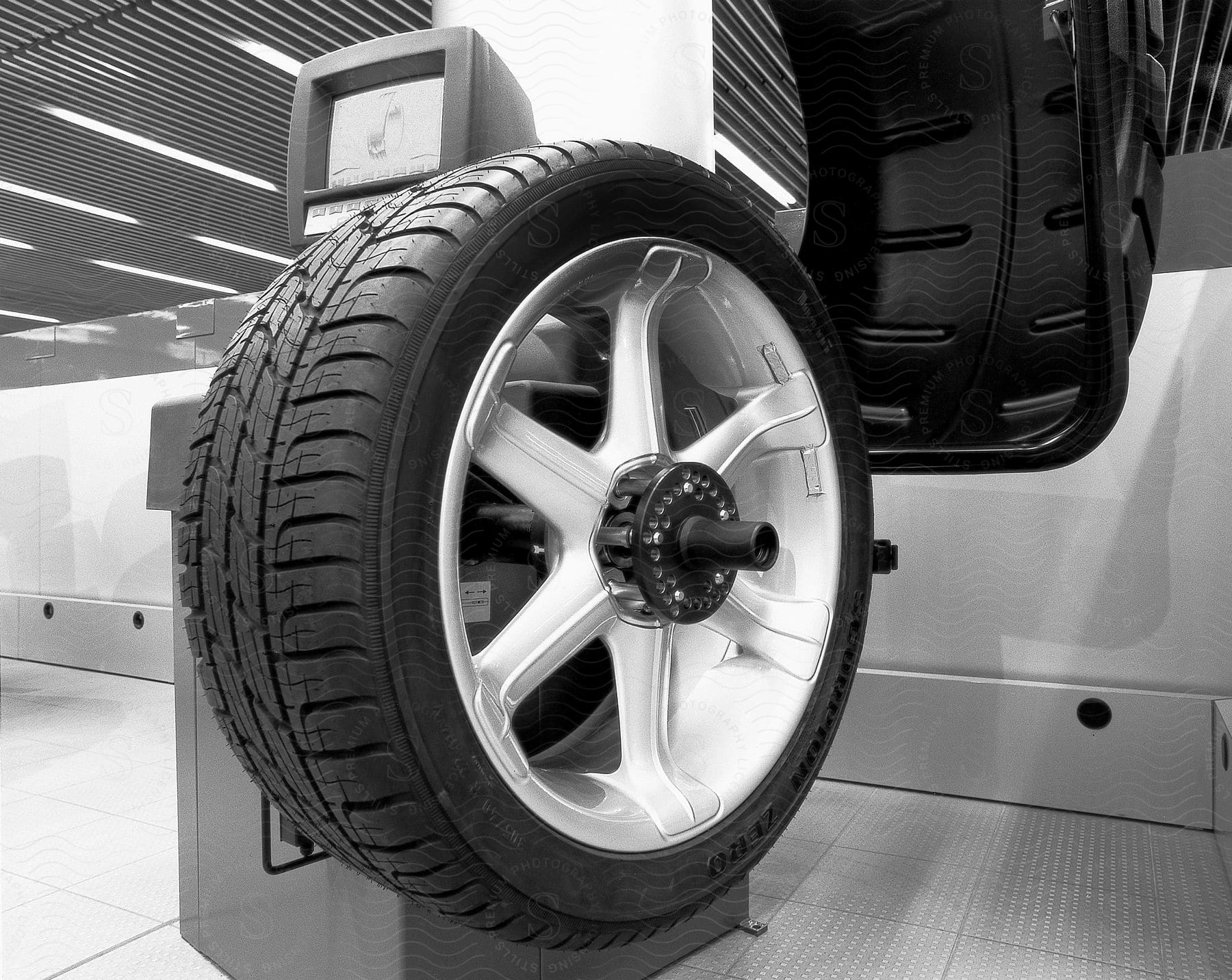 An automobile tire hanging on testing machinery