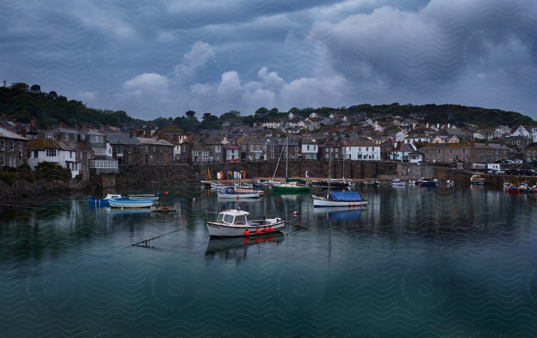 A city by the water with boats on a rainy evening