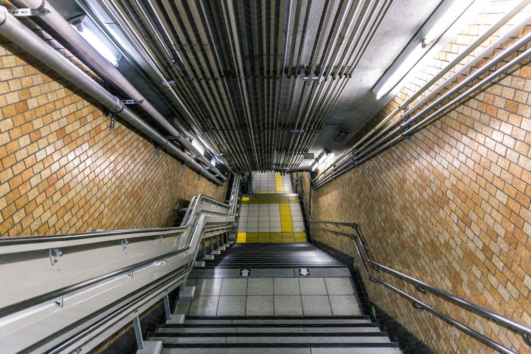 Corridor with stairs and handrail attached to the wall