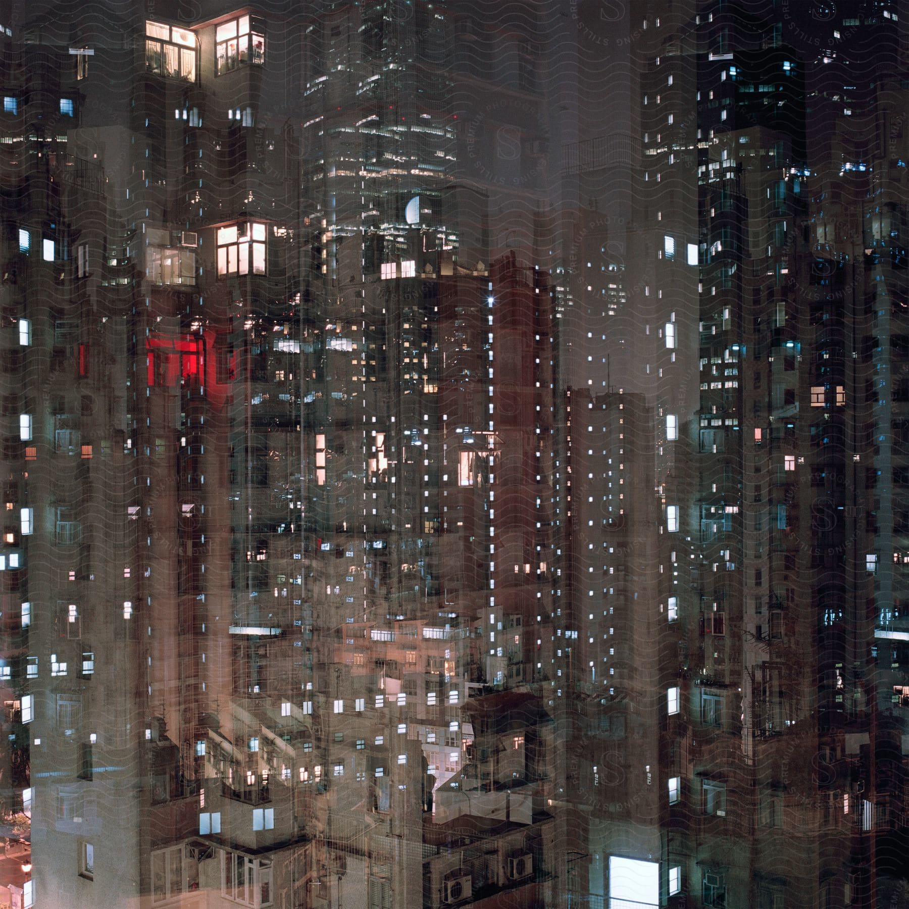 A nighttime scene from inside a highrise building showing other skyscrapers in the cityscape