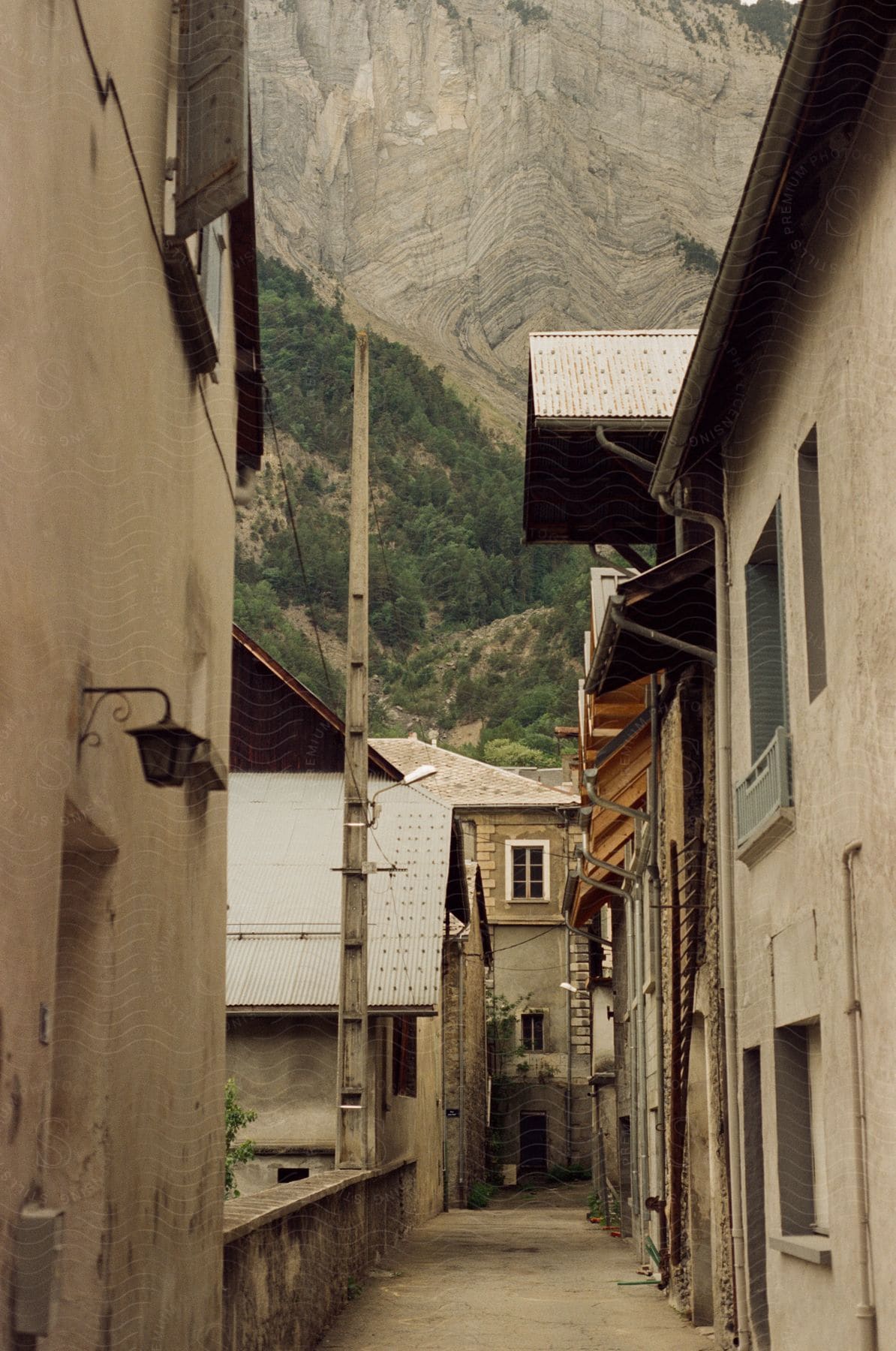 A Village With Houses Mountains And Forest In The Background