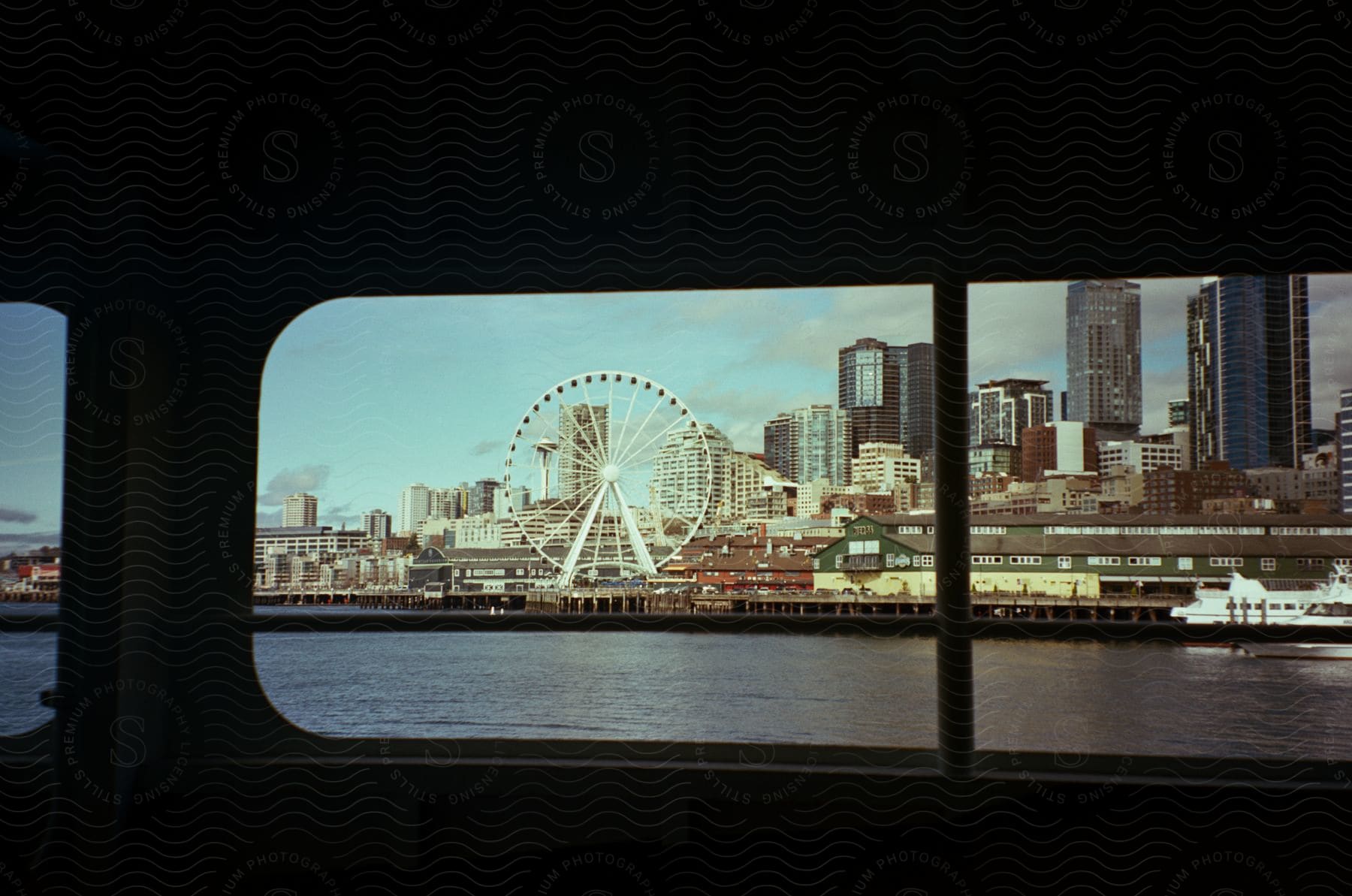 Seattle skyline and ferris wheel seen from a ferry window