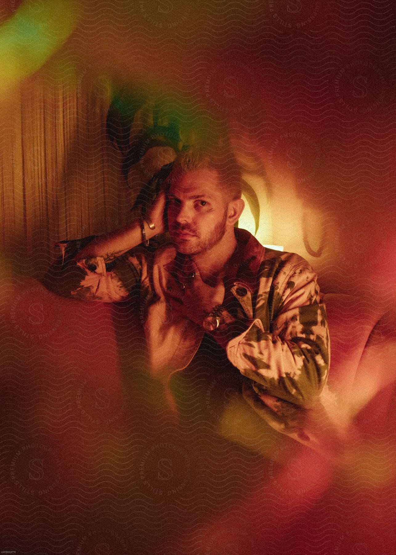 A man sitting on a couch posing for a photo