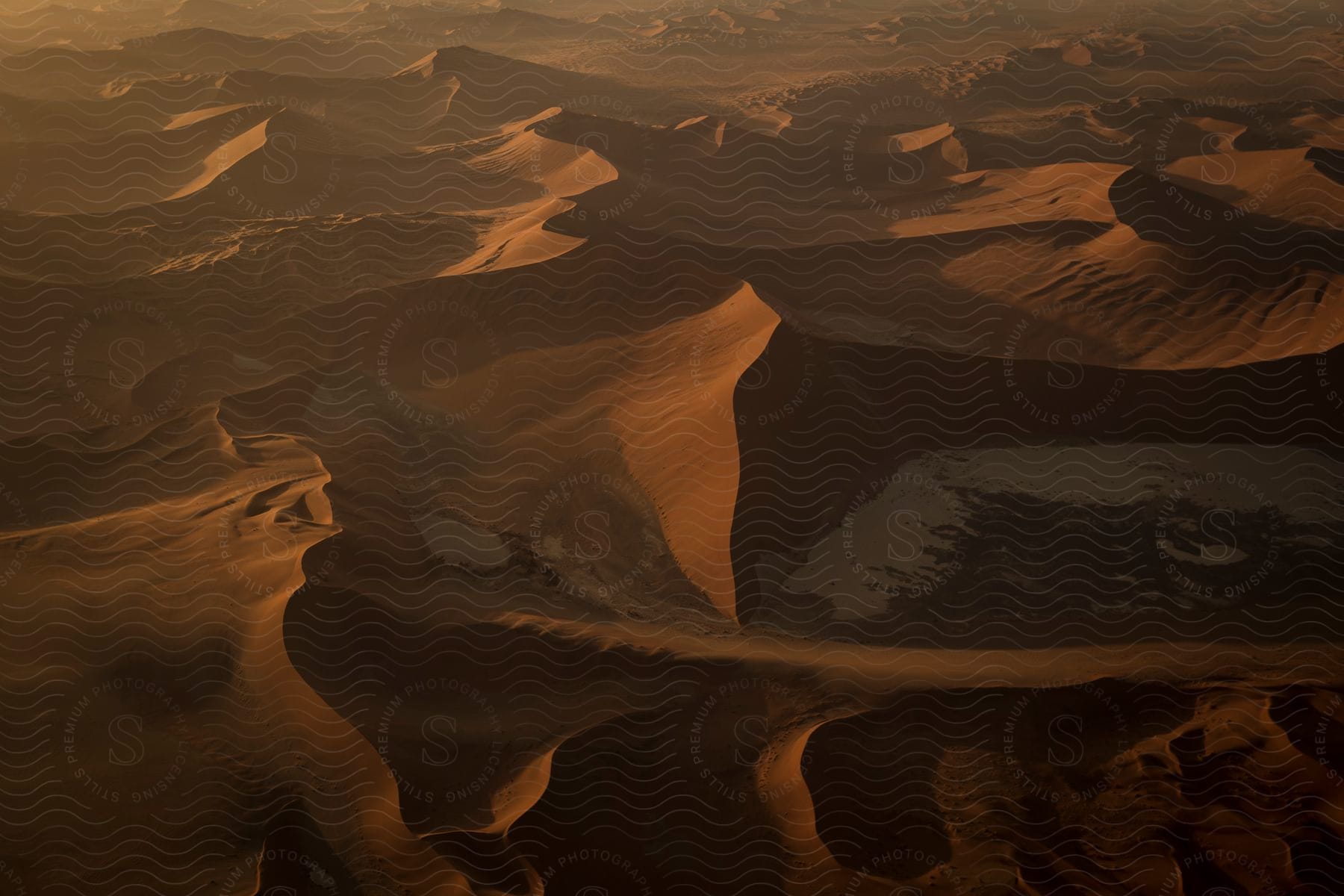 A barren desert landscape with a brown color palette and clear blue sky