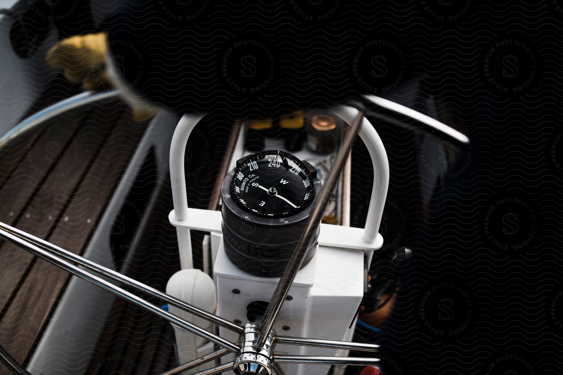 A compass and steering wheel of a boat