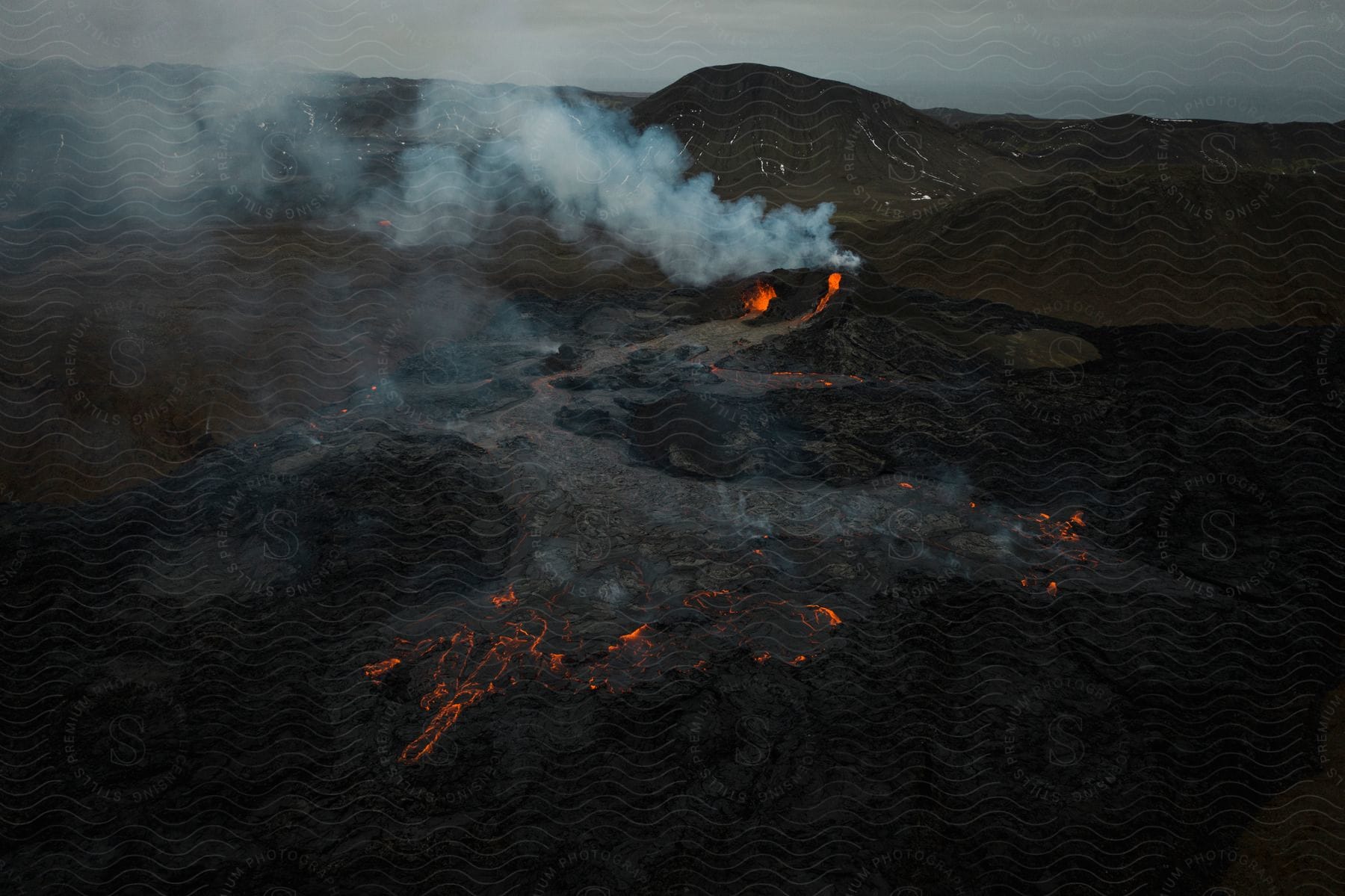 Molten lava seeping through cracks in the ground