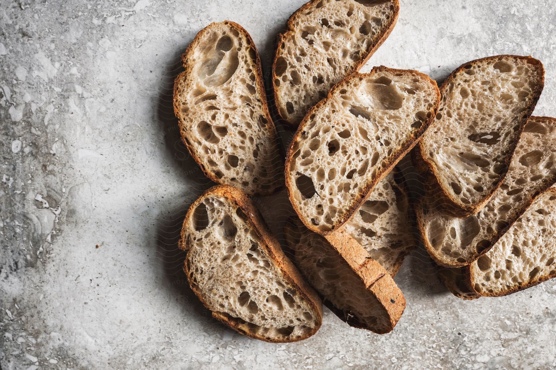 Pieces of bread are arranged together on a surface