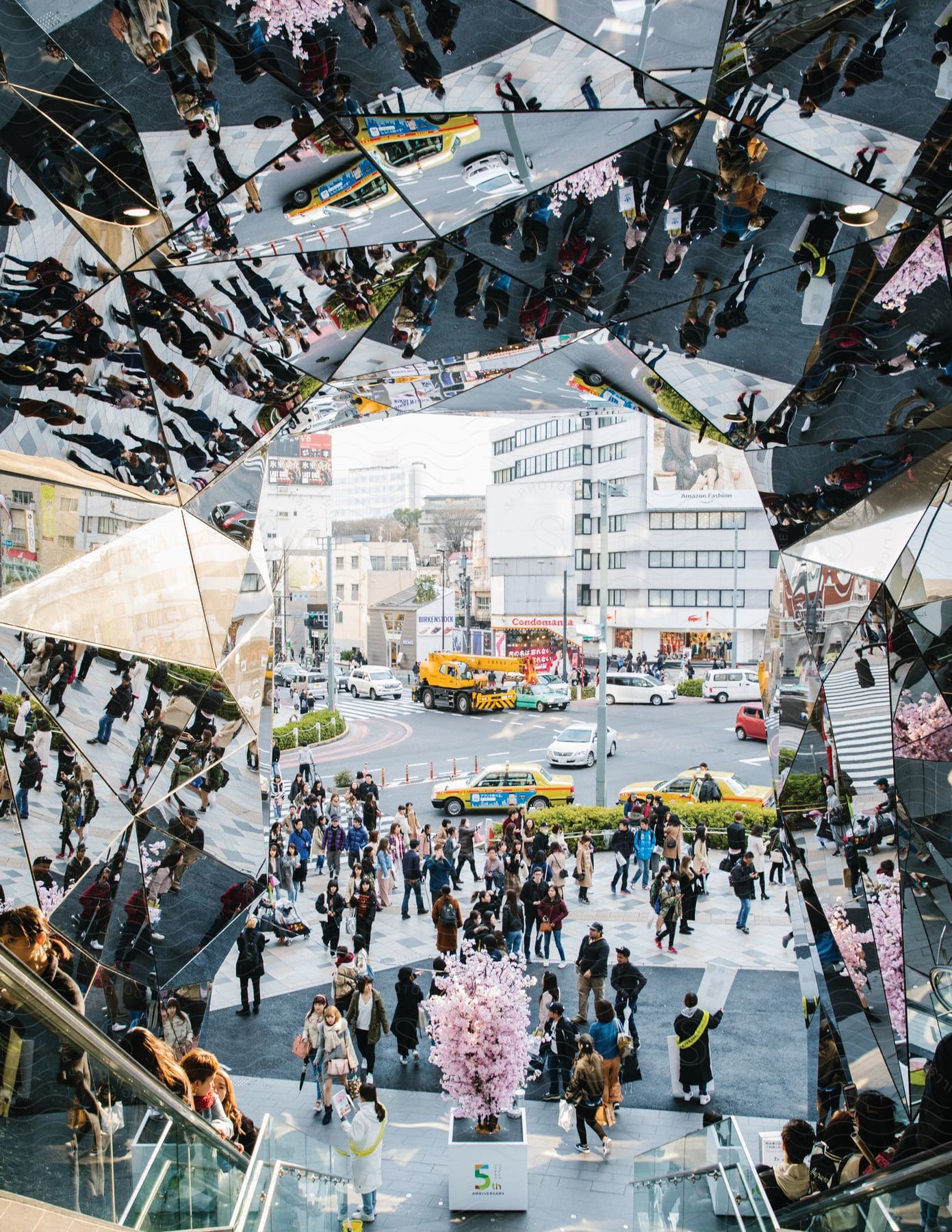 A cityscape seen from a staircase with mirrors