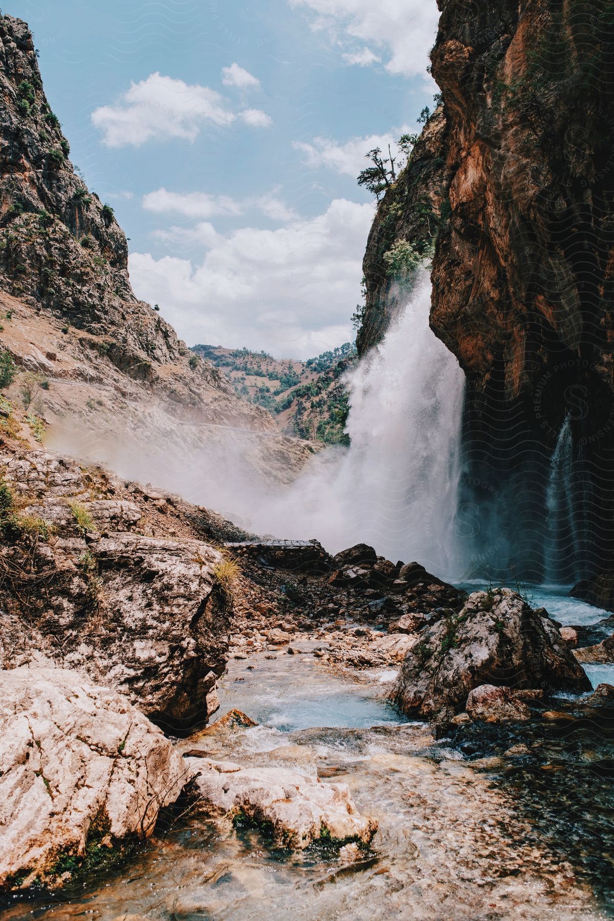 A waterfall flowing into a lagoon in a valley