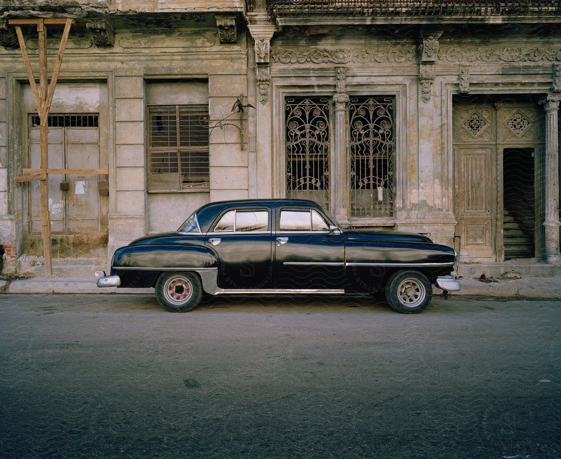 A car parked in front of an old building