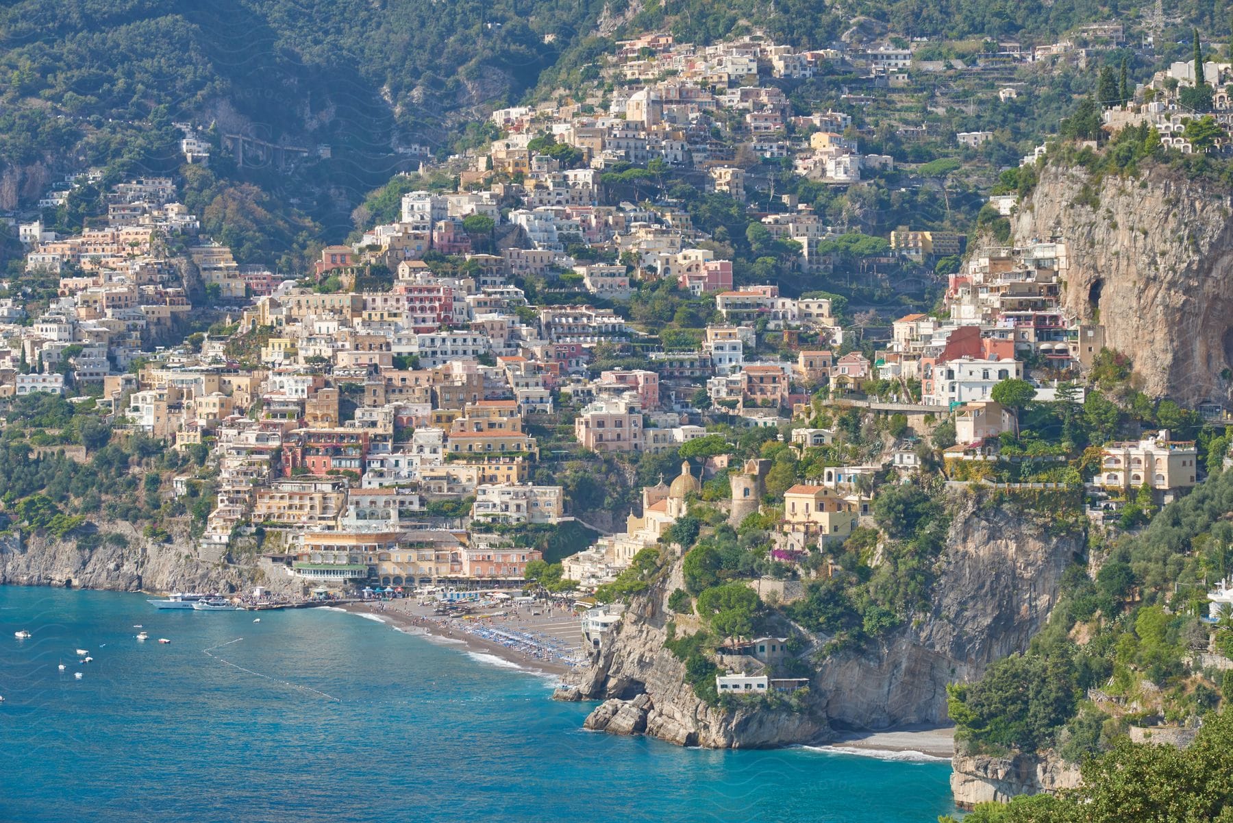 Aerial view of a coastal landscape with mountains and water