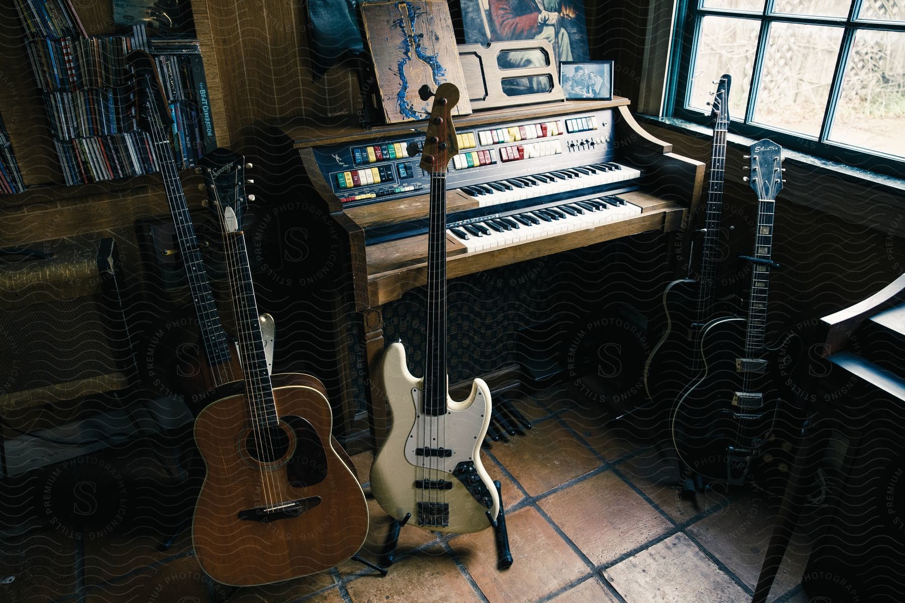 Guitars and keyboards are positioned near windows in the corner of a room