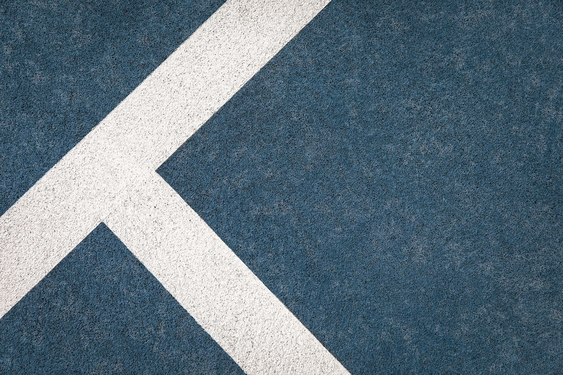 A grey asphalt road with a textured surface