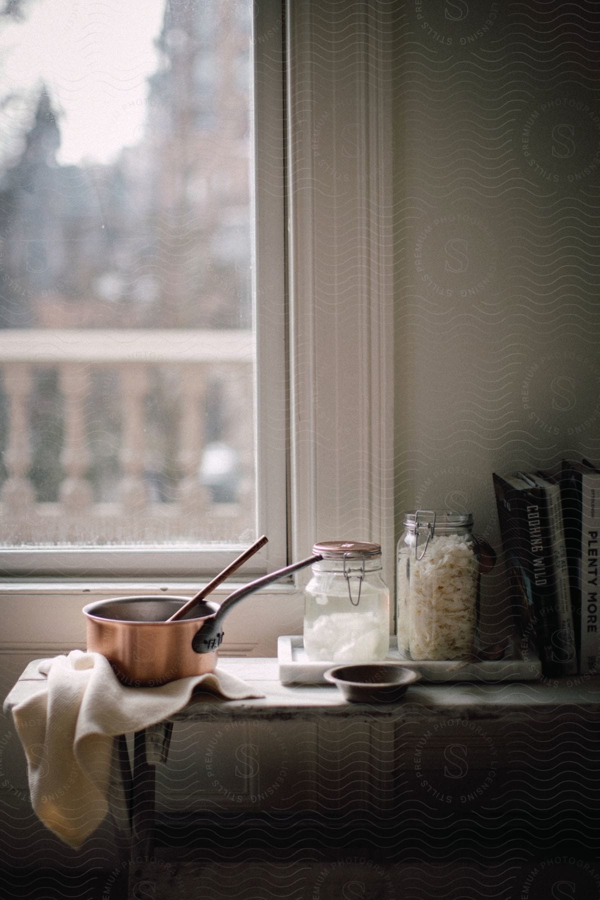 Sauerkraut making ingredients and apparatus on narrow table near window