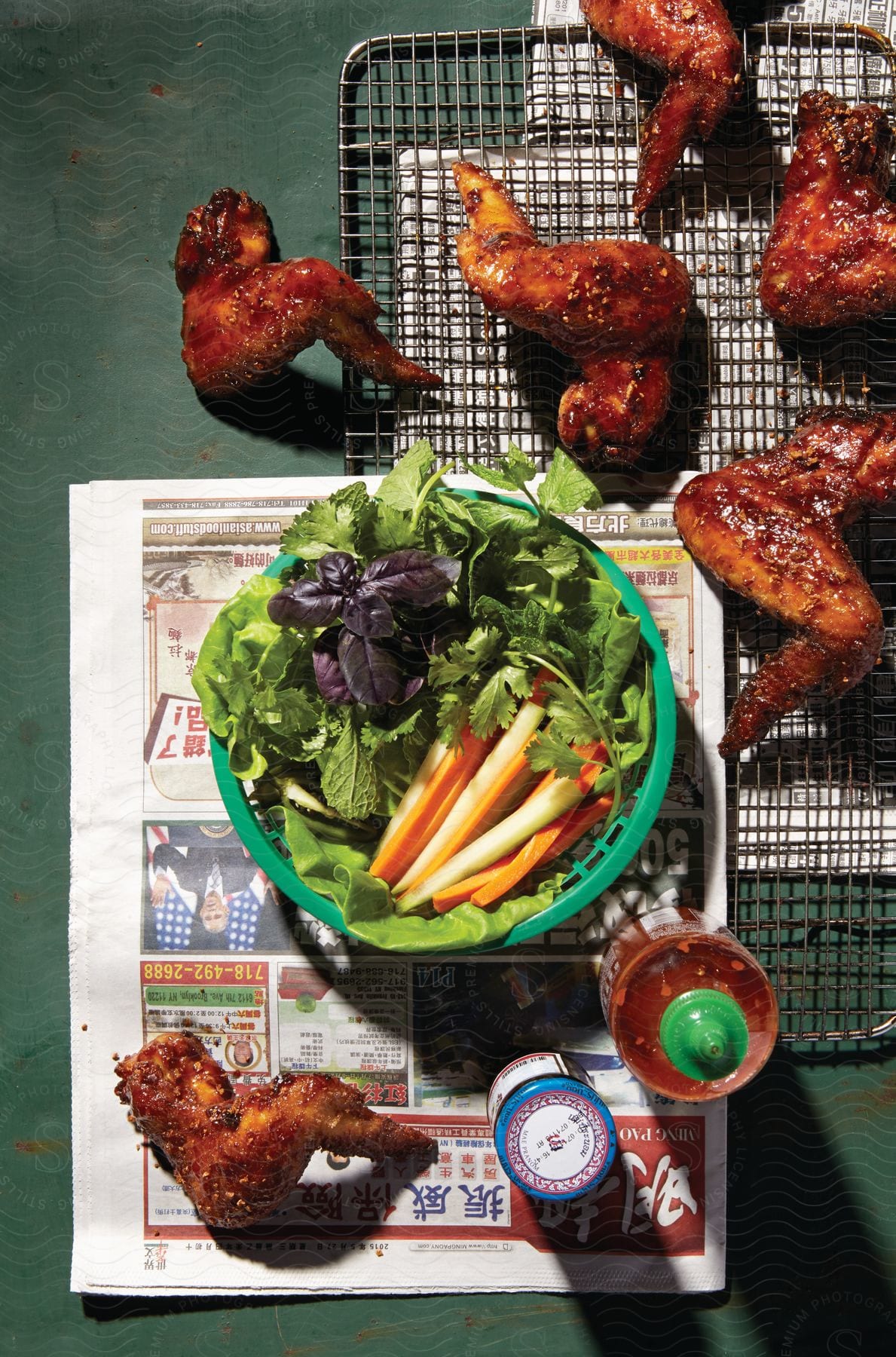 A Bowl Of Vegetables Surrounded By Six Fried Chicken Wings