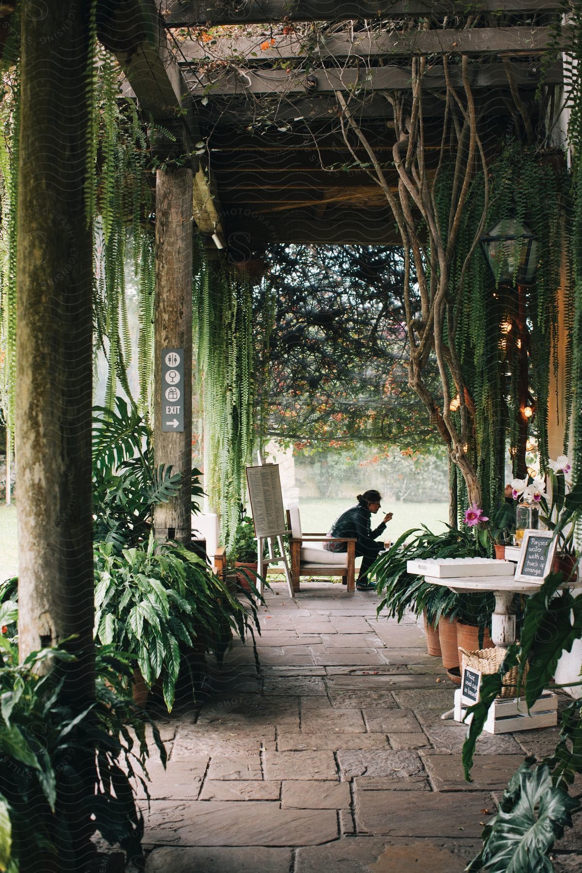 A man is eating on a restaurant patio