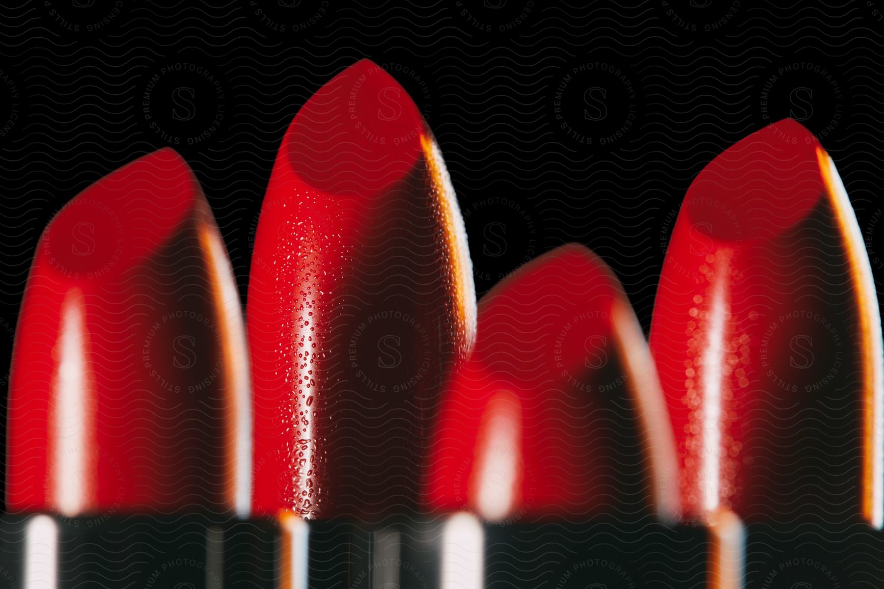 Four Red Lipstick Tips Placed Side By Side