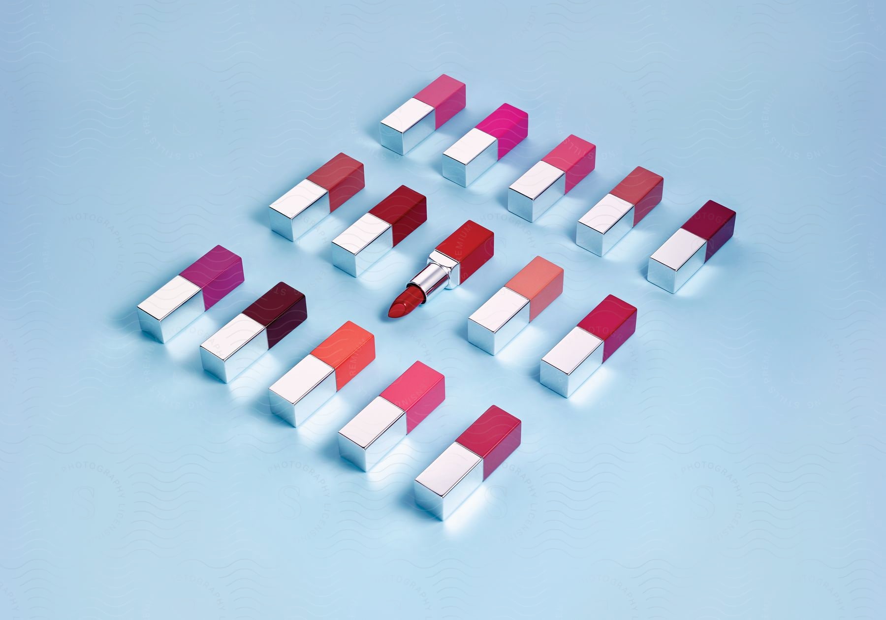 Stock photo of close up of lipstick tubes on light blue background