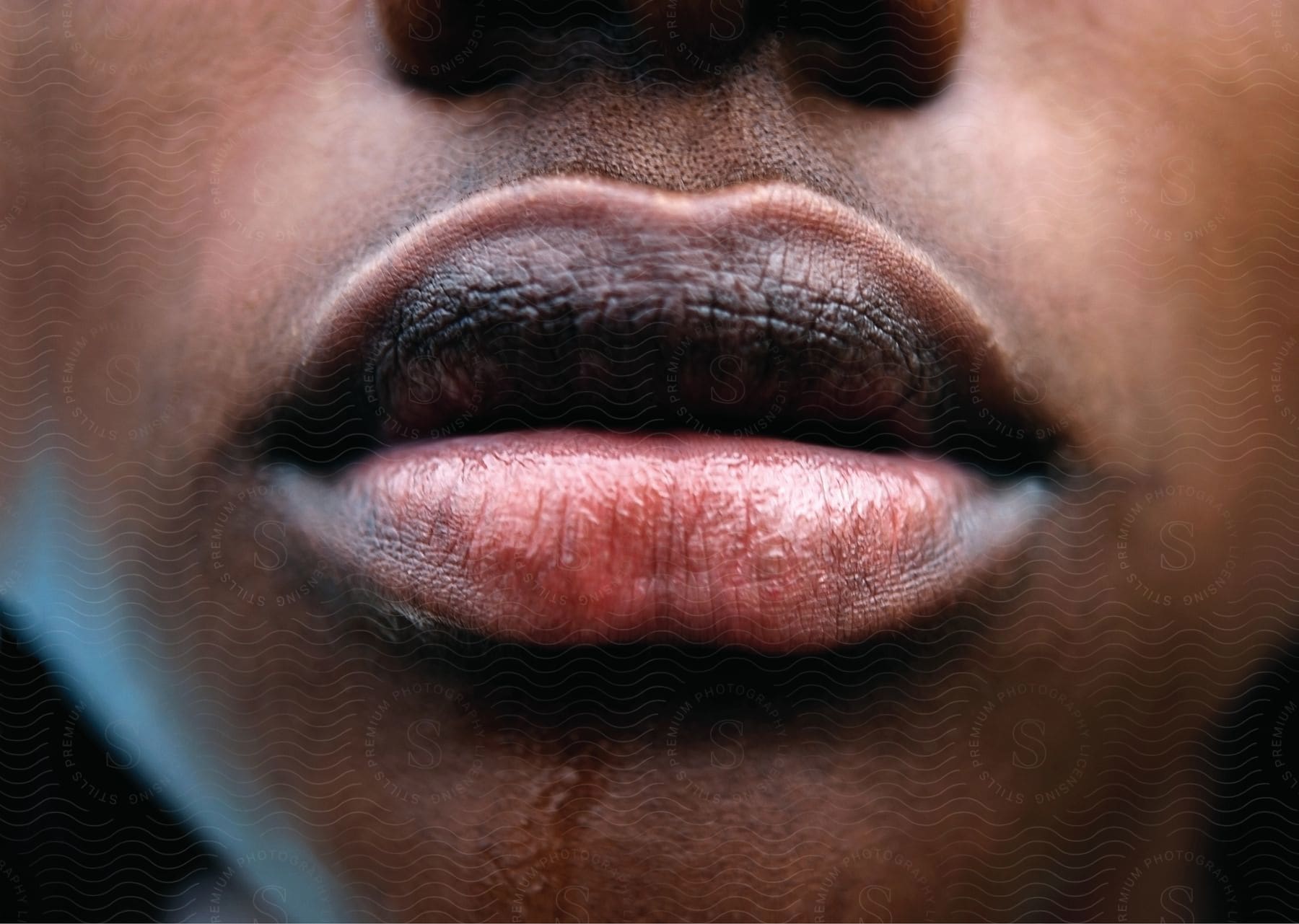 A closeup of the lips of a person with dark skin