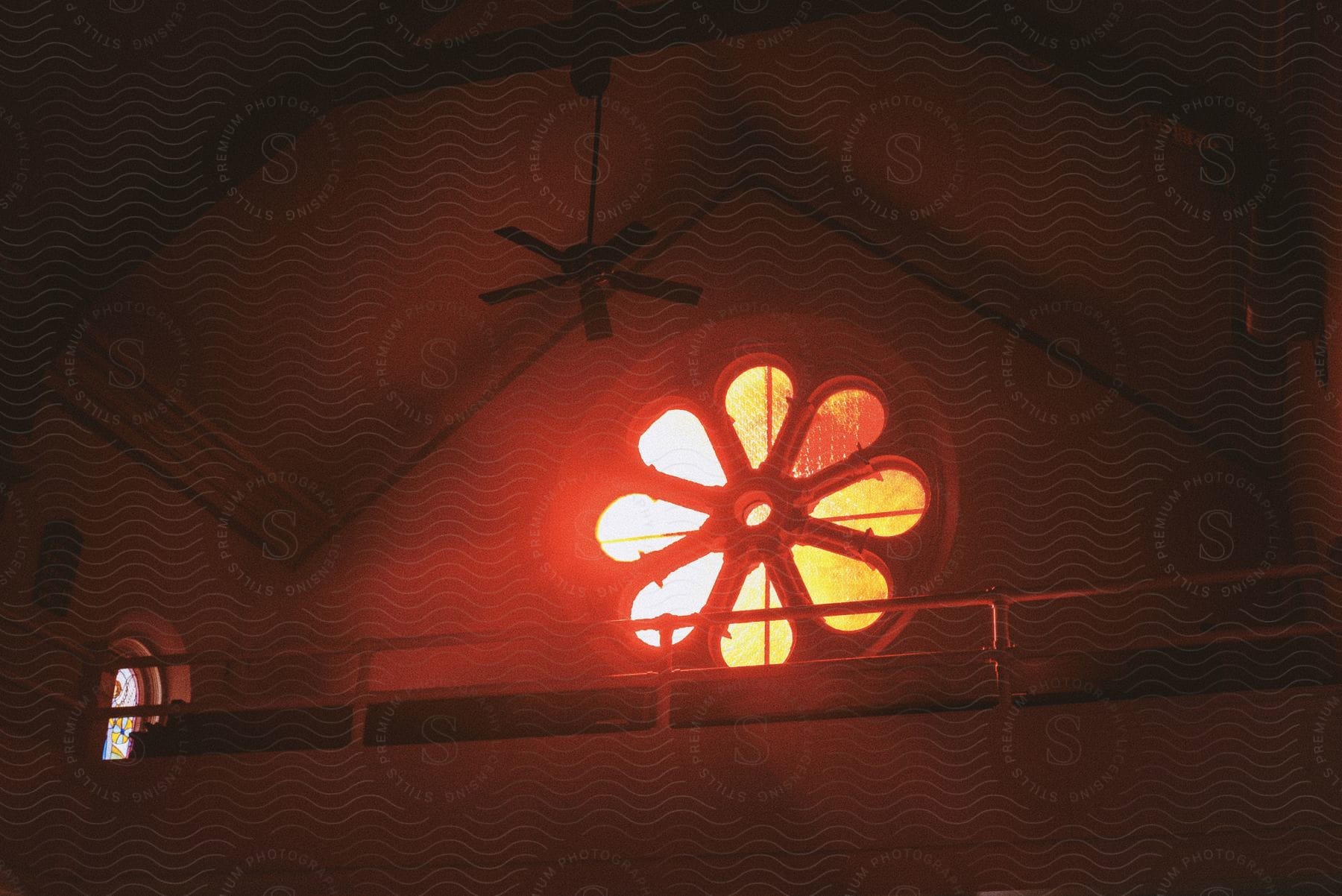 An amber ceiling fan in a neutral setting