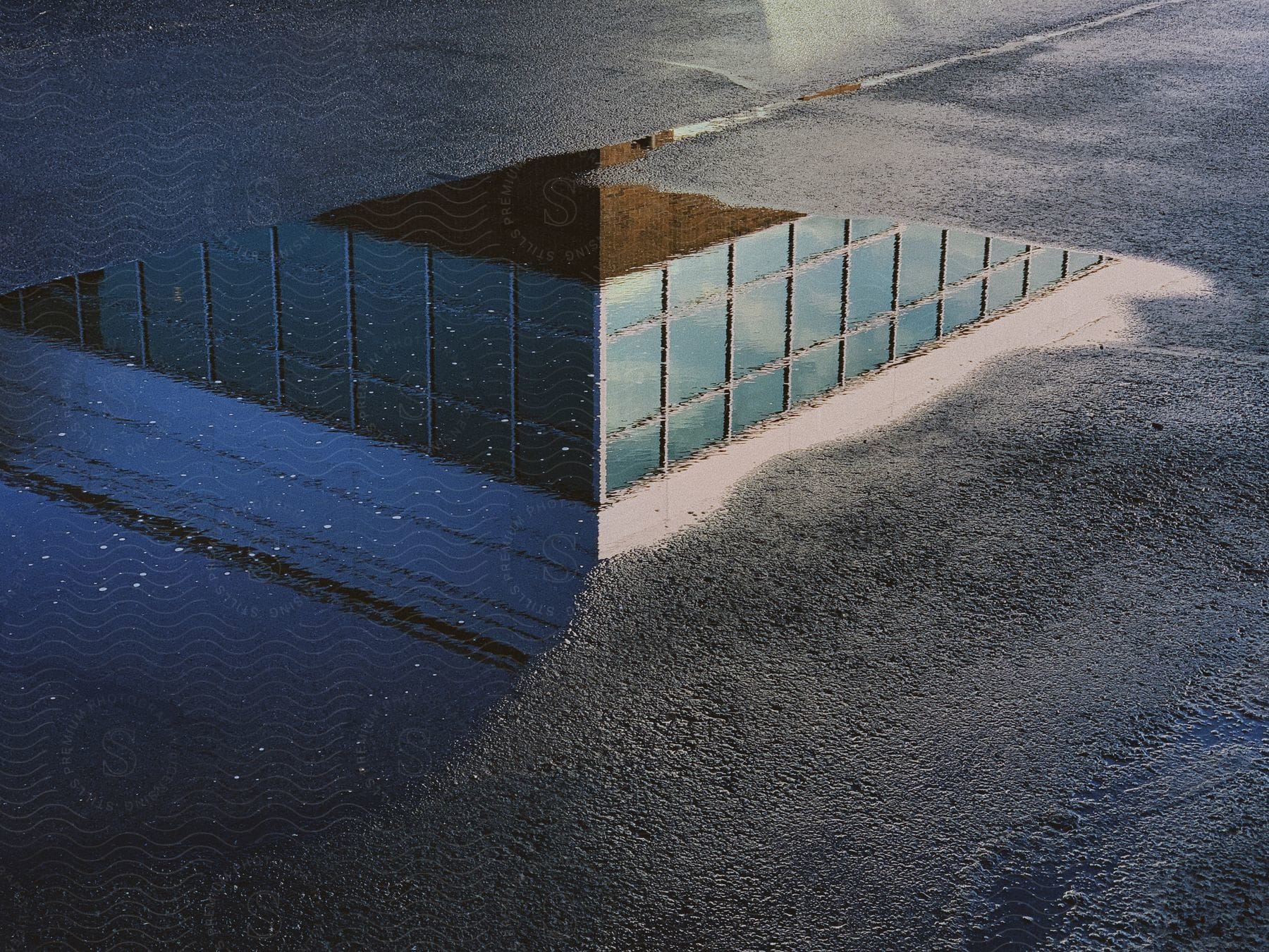 Digital art of a white square on asphalt with glass grids inside