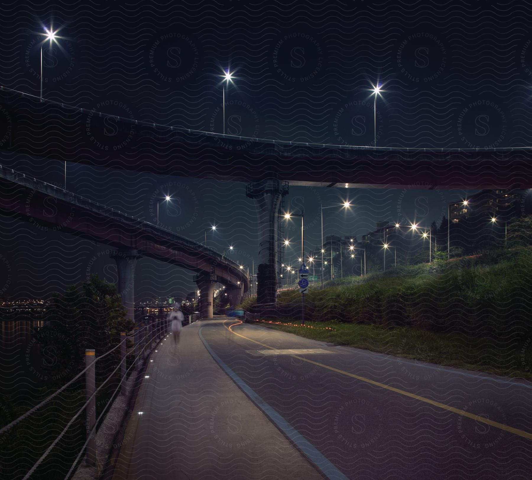 Road at the coast under two bridges next to a city