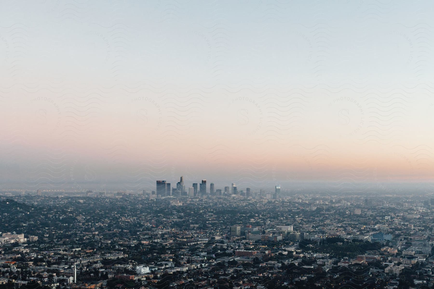 Aerial shot of a city with downtown skyscrapers in the distance