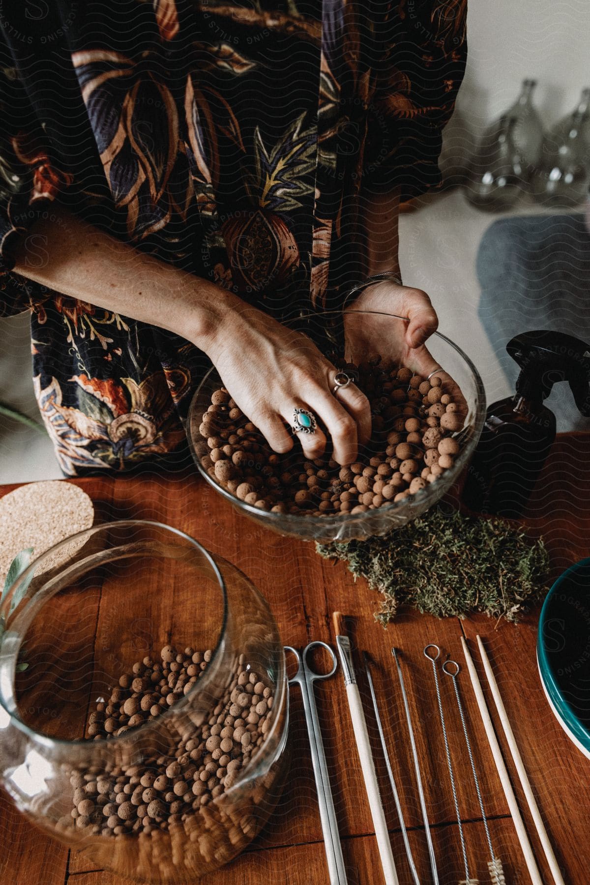 A woman pouring chocolate from one bowl to another bowl in a kitchen