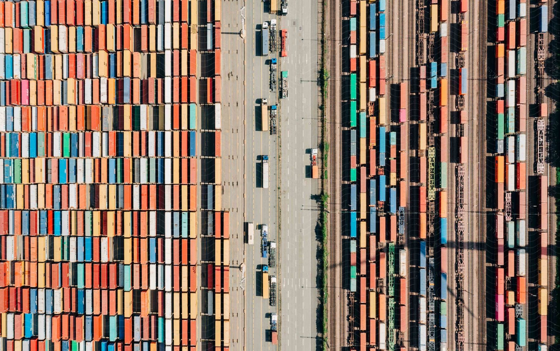 A shipping yard with containers trucks and trains