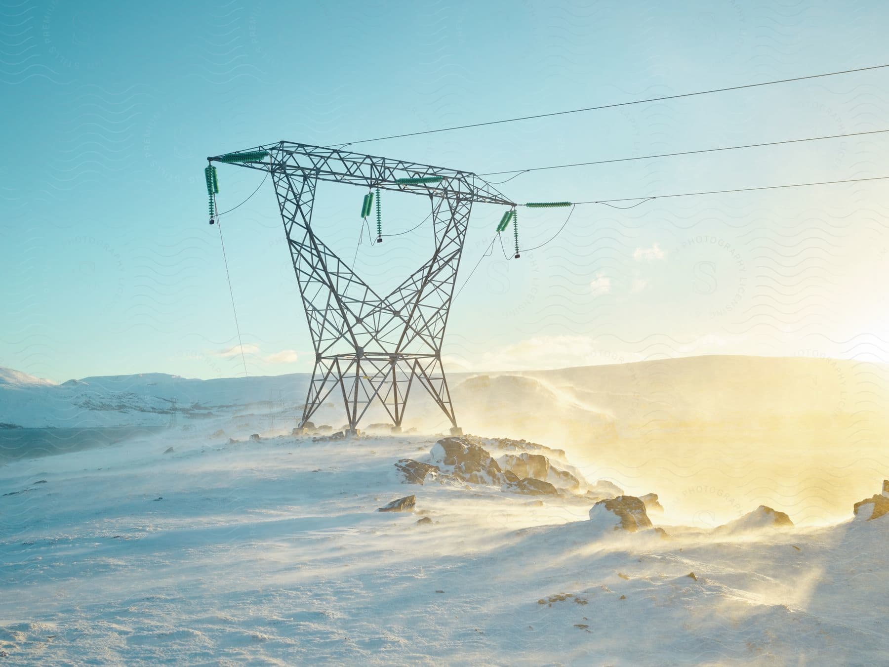 An electrical transmission tower in snowy mountains