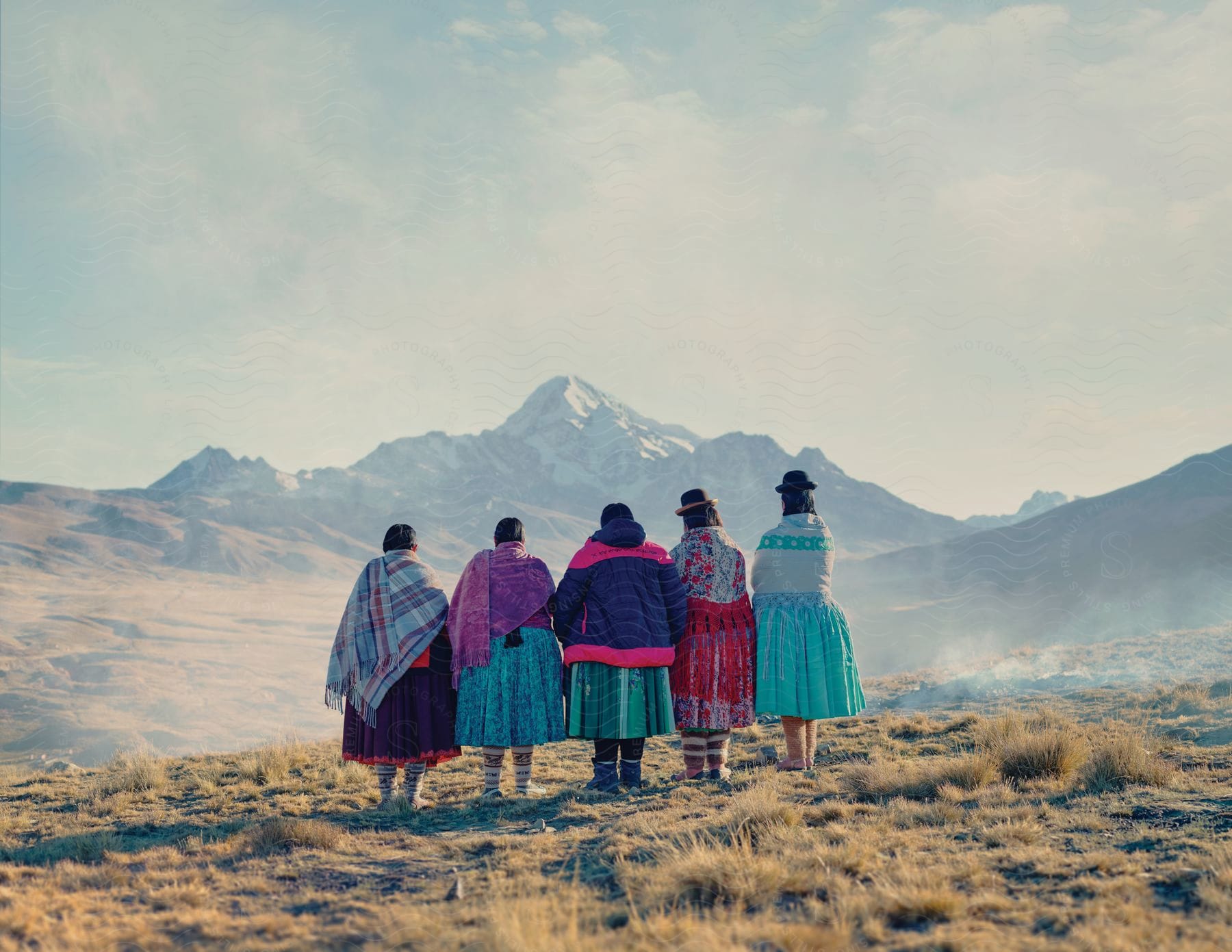 Peruvian women observing a snowy mountain