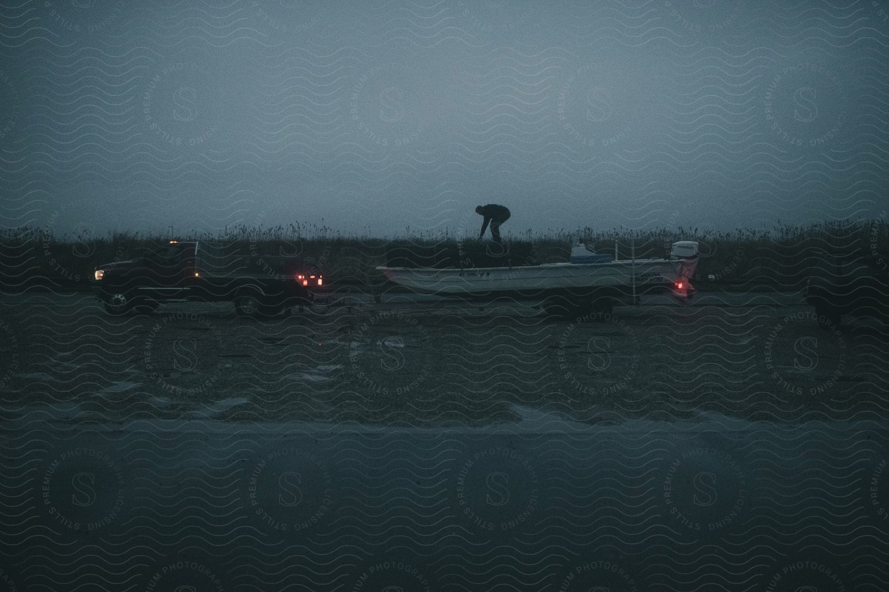 A determined person driving a car on a road at dusk