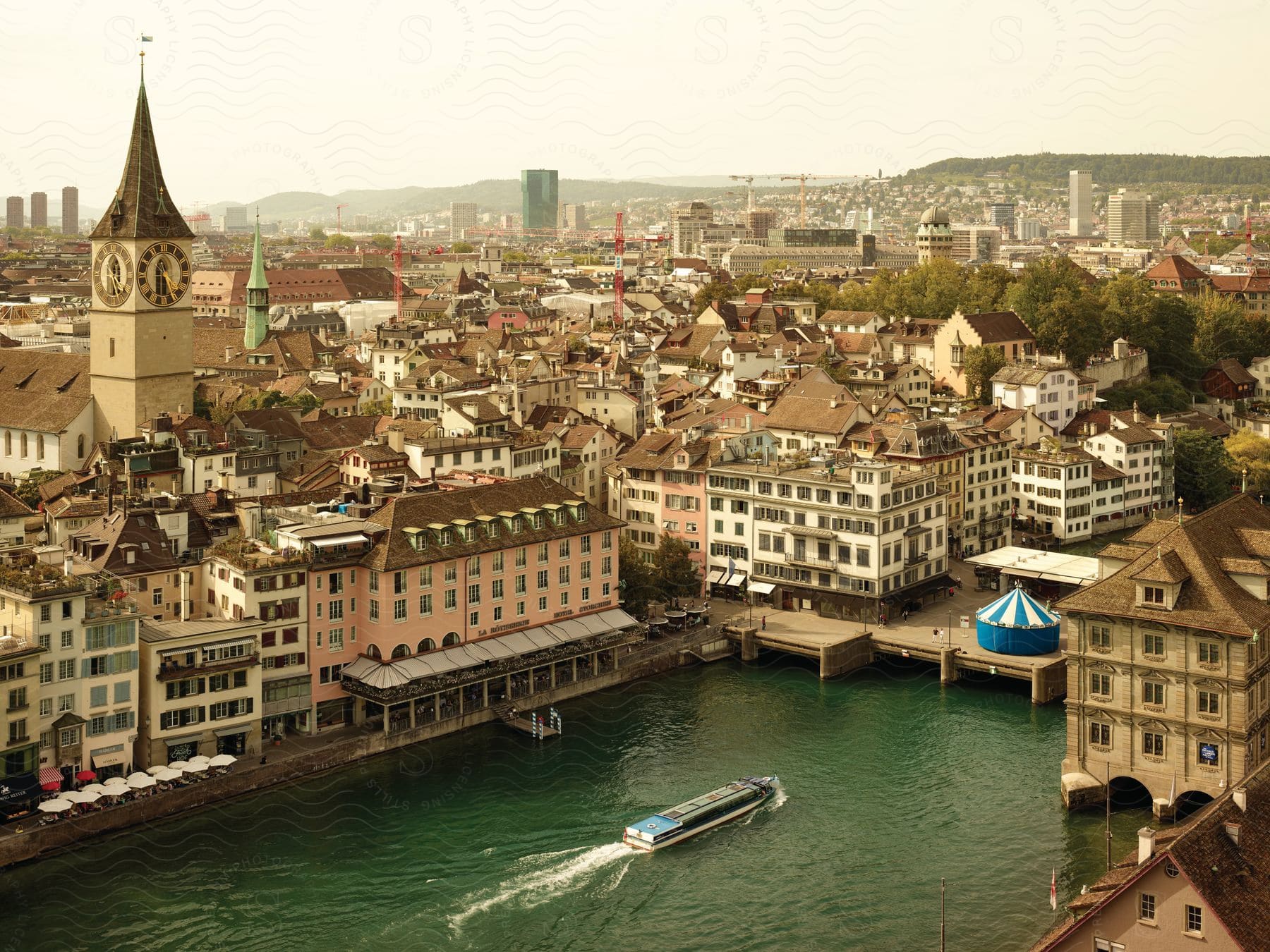 A city with old houses and a river with a canoe in the middle