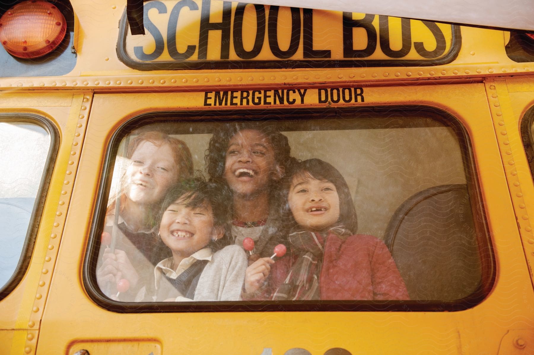 A group of students traveling on a school bus and laughing