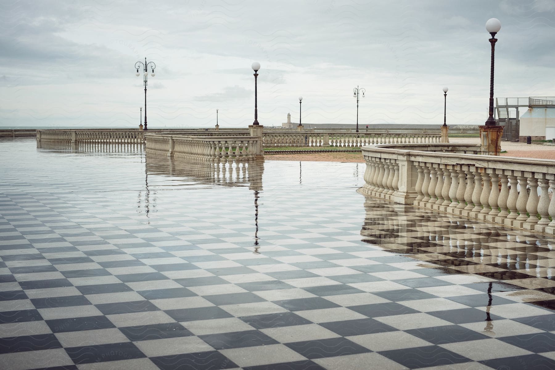 A night view of the terrazza mascagni in livorno with water lamps checkered marble floor and no people