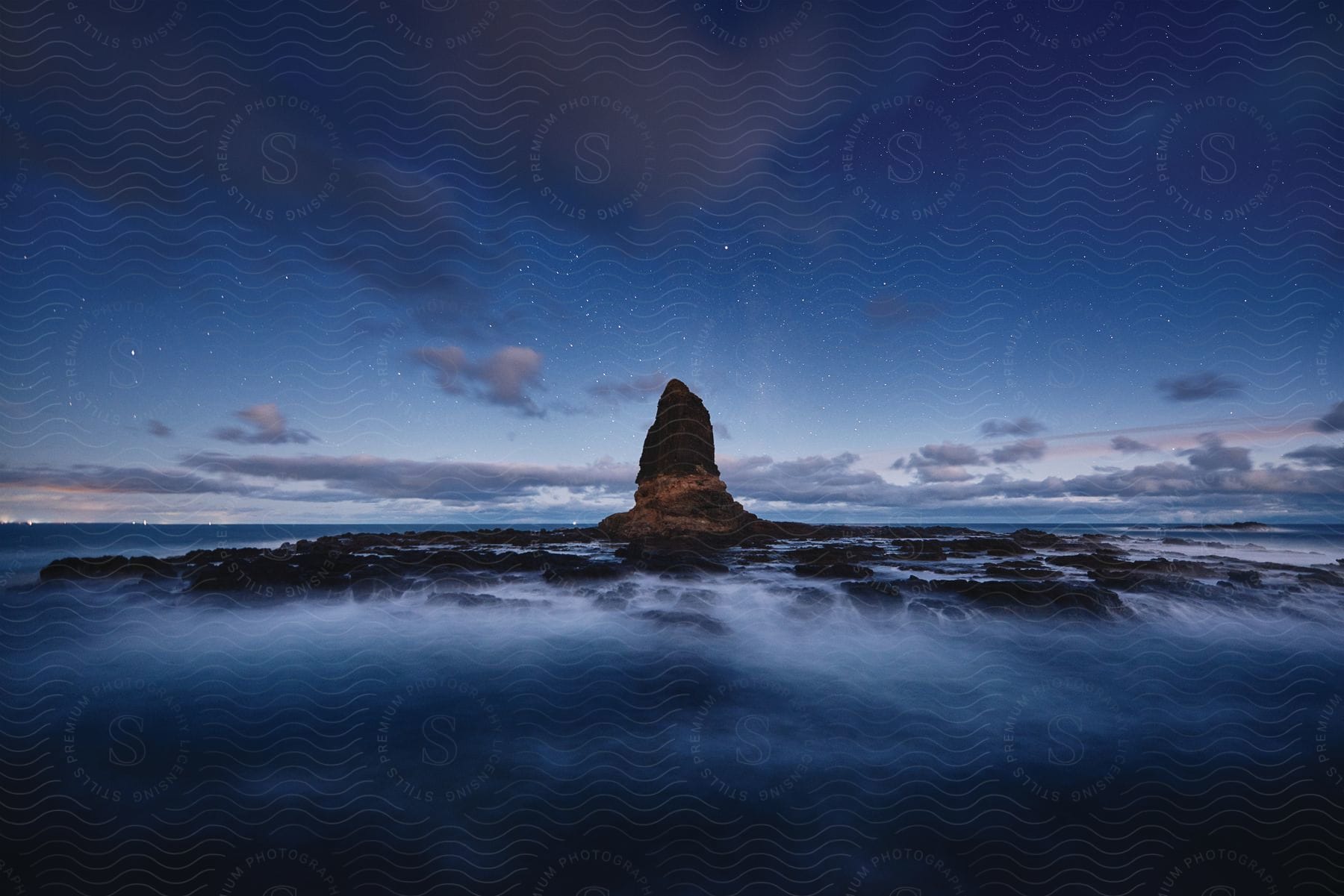 A distant mountain peak is visible over the sea