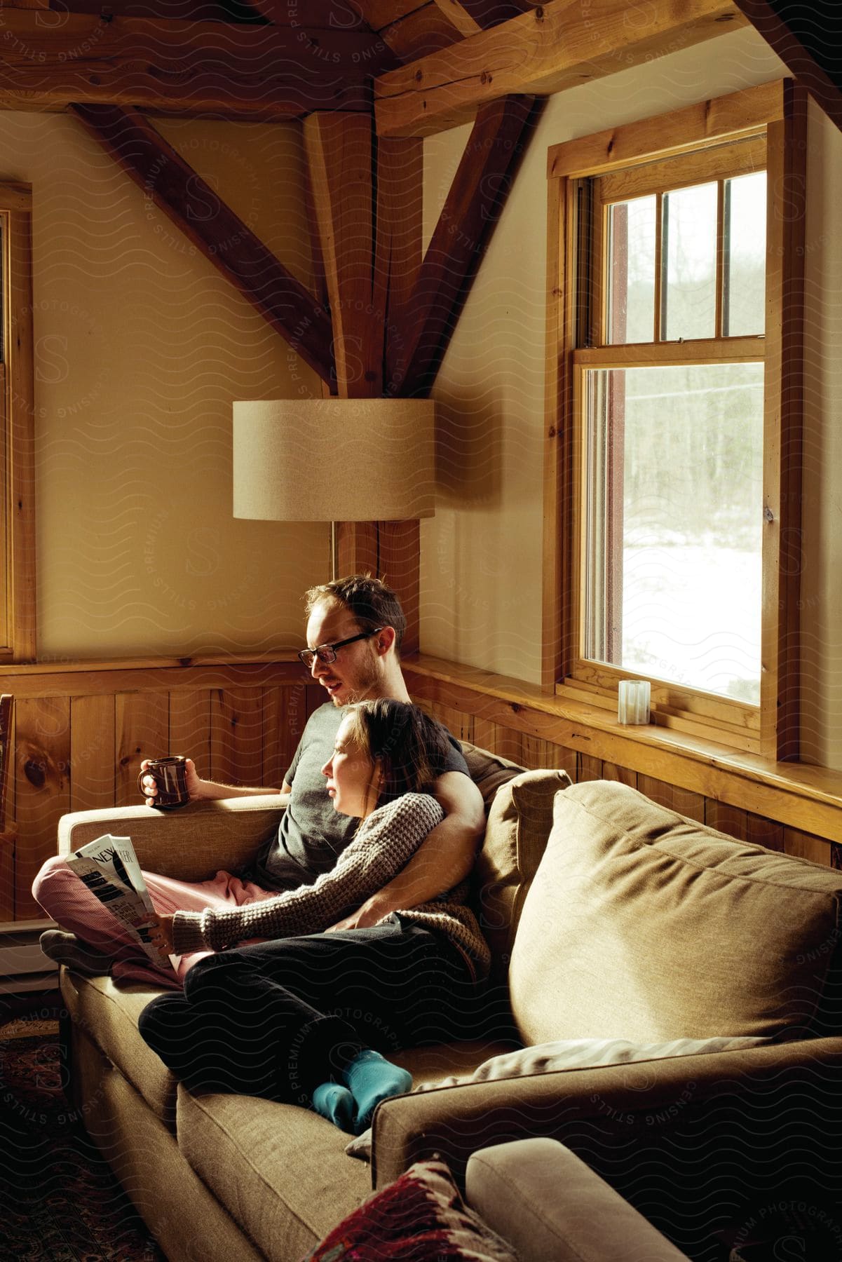 A couple sitting closely together on a couch