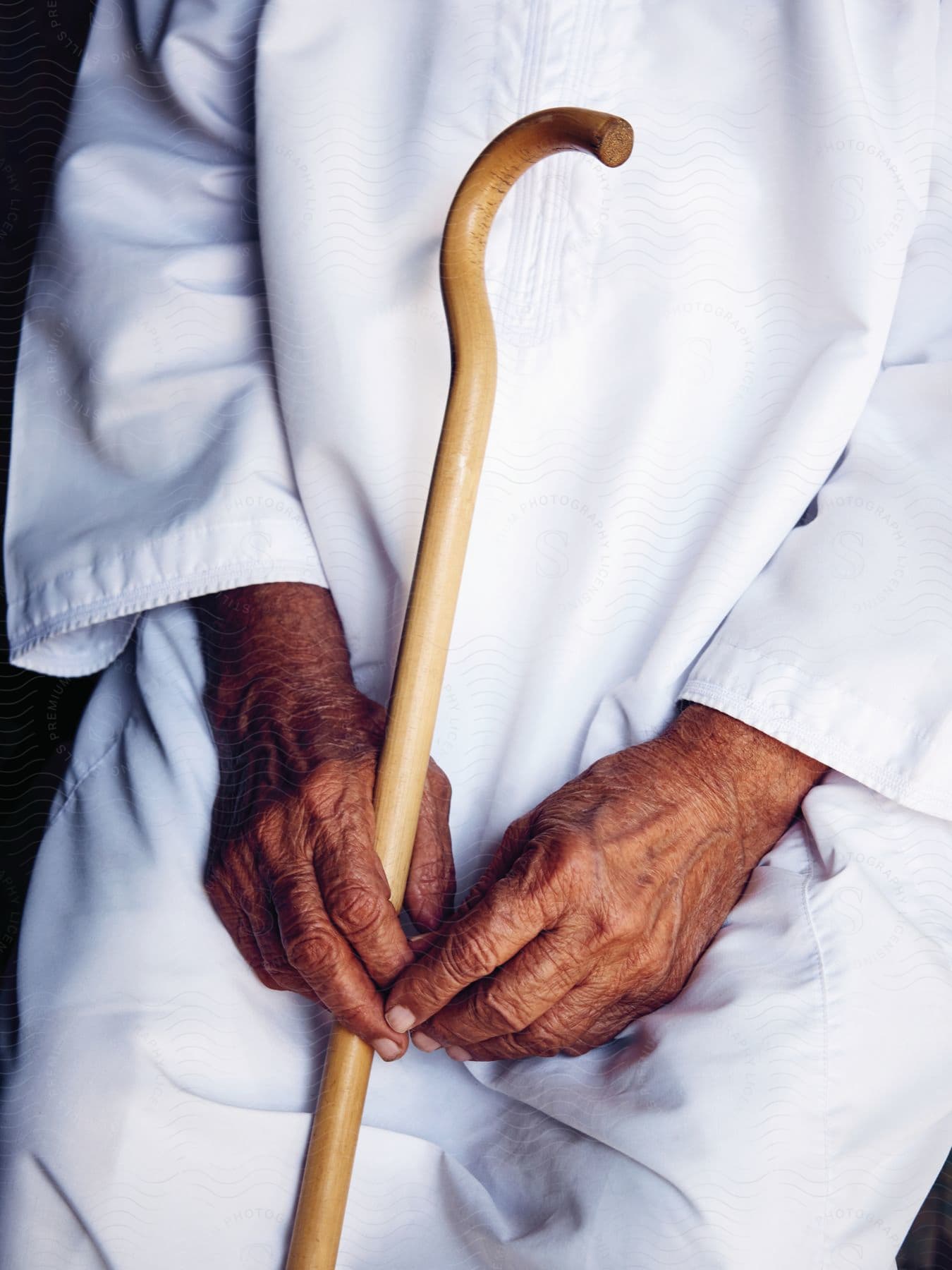 An elderly person holding a cane