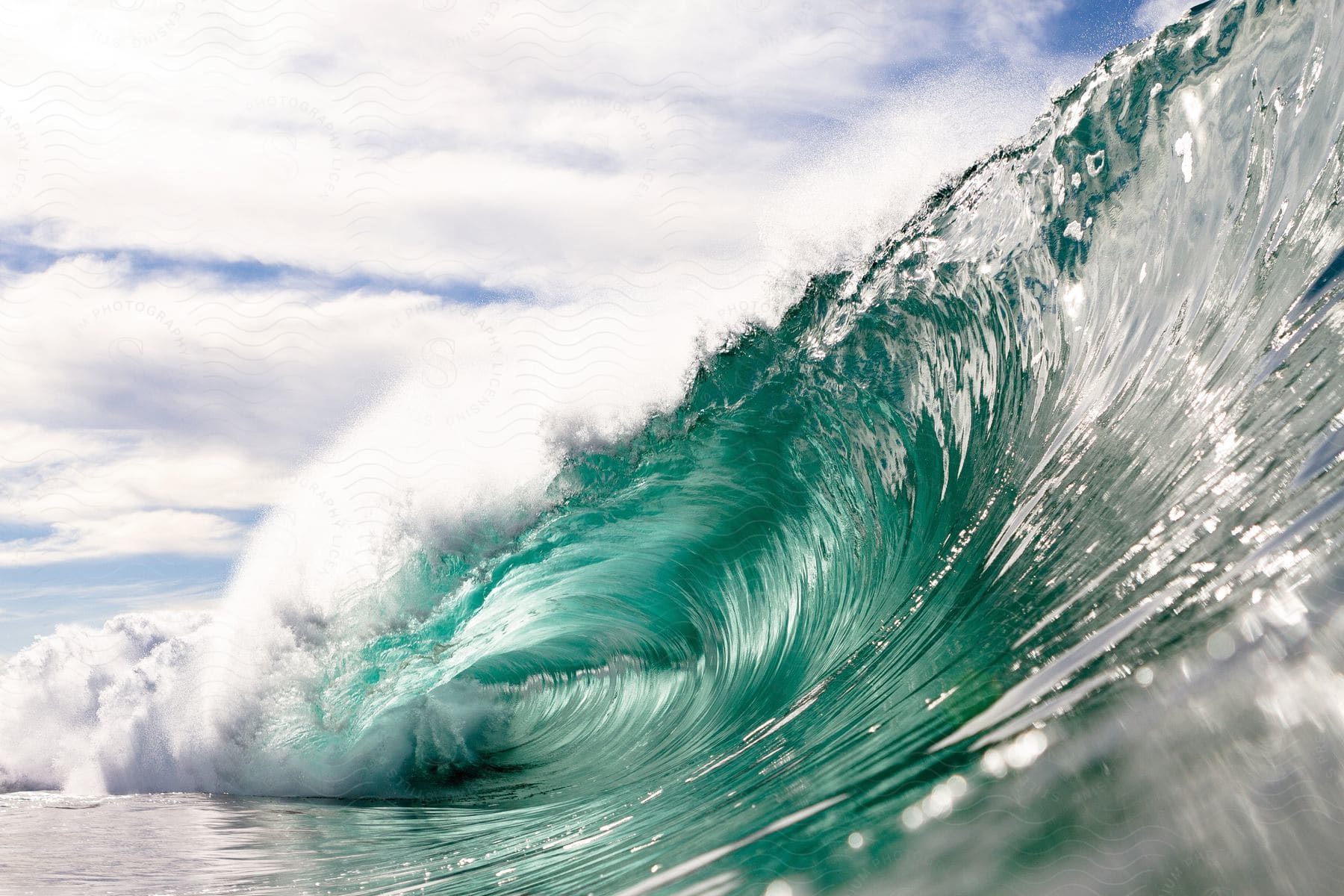 A tranquil scene of the sea with rolling waves under a cloudy sky