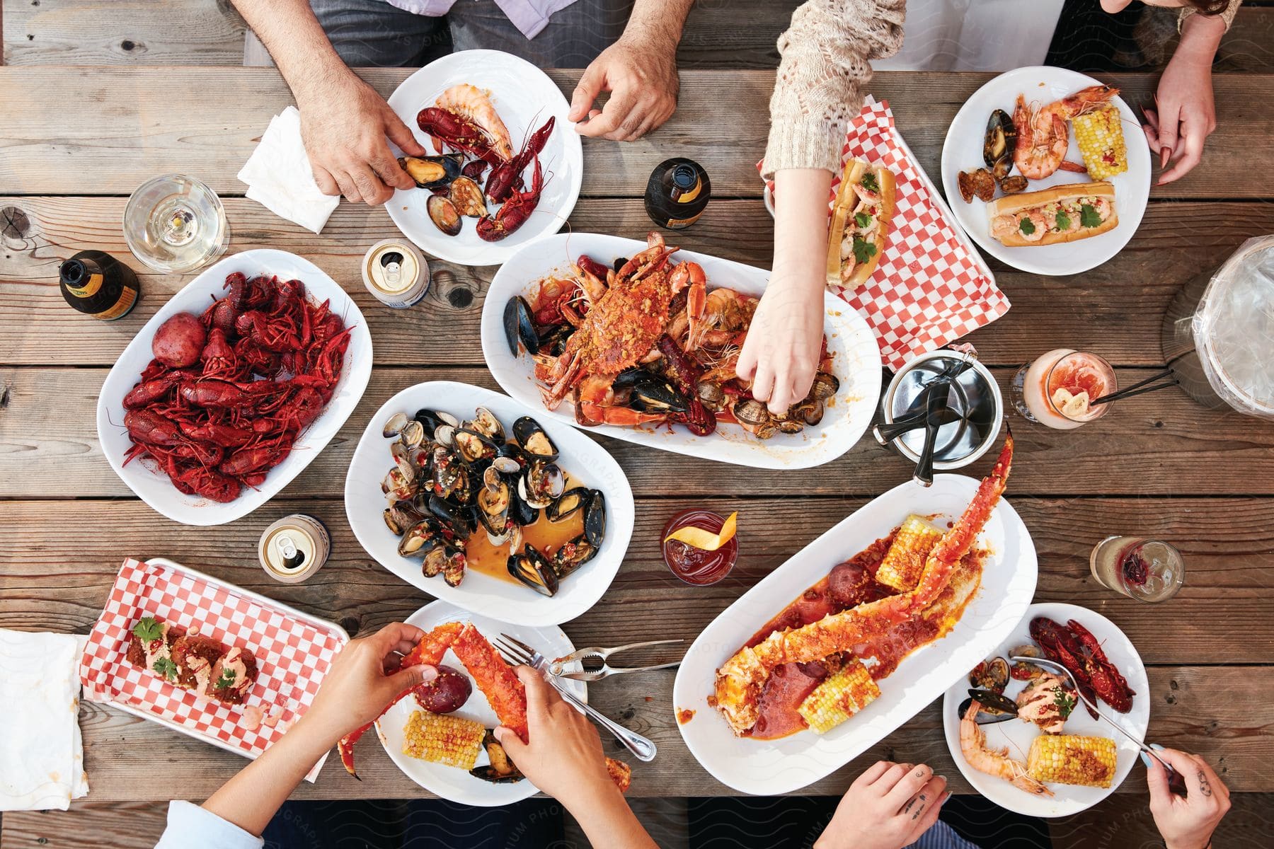 A man prepares a brunch dish on a table with plates and ingredients