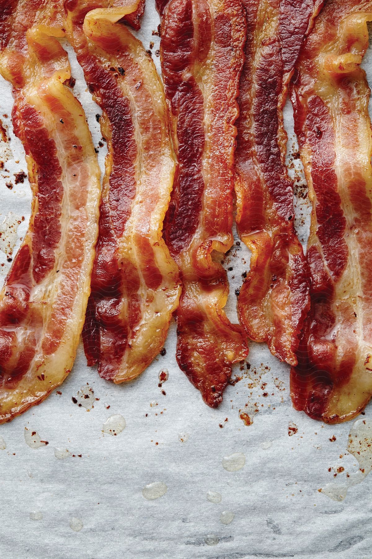 Cooked bacon strips laid out on paper