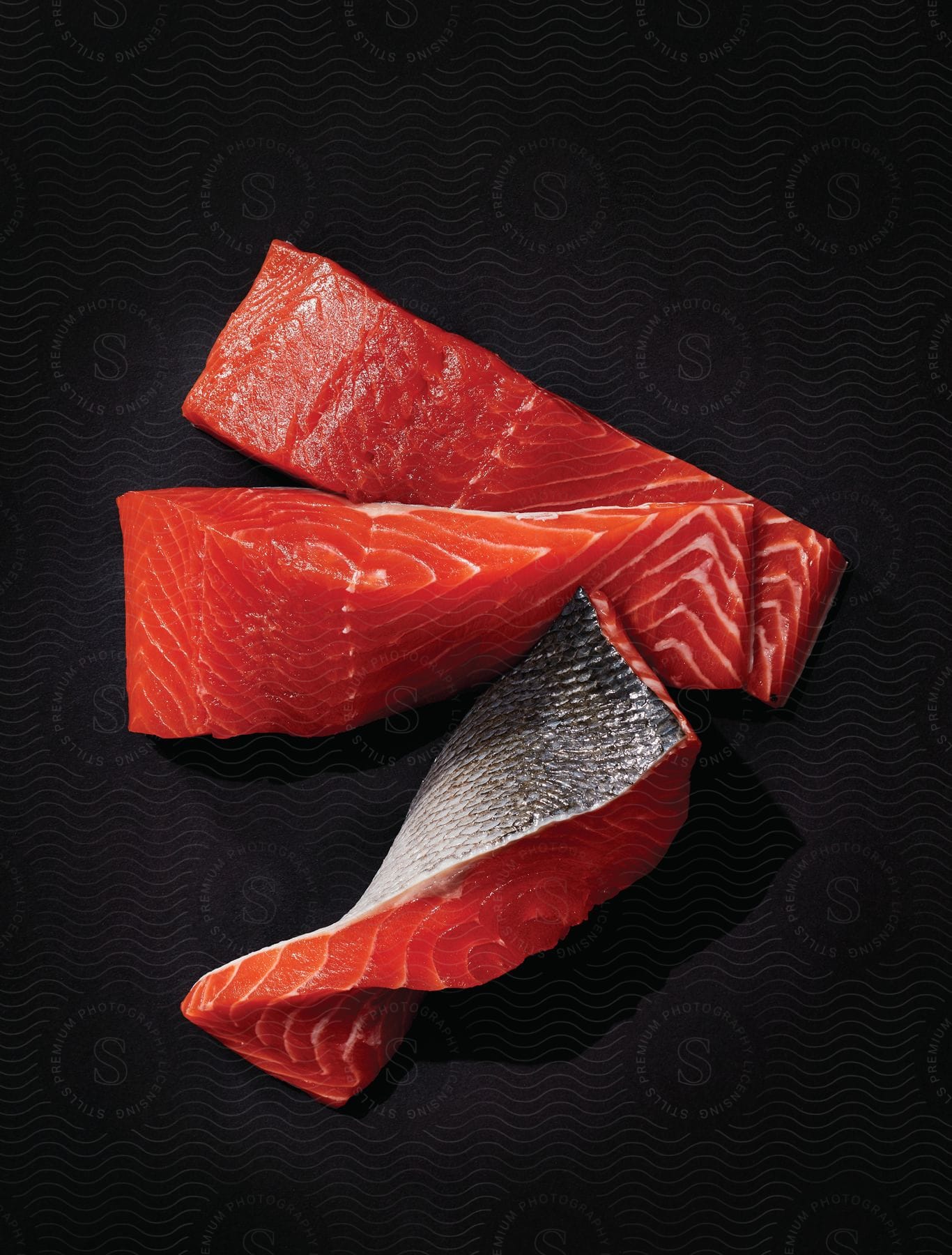 Raw salmon on a black table