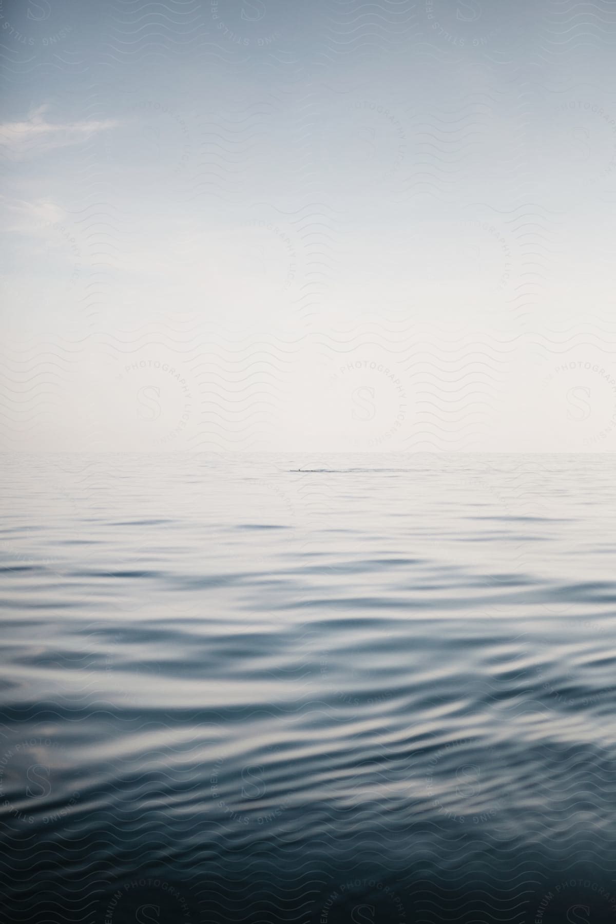 Sunlight Shines On Ripples And Waves On Water Under A Cloudy Sky