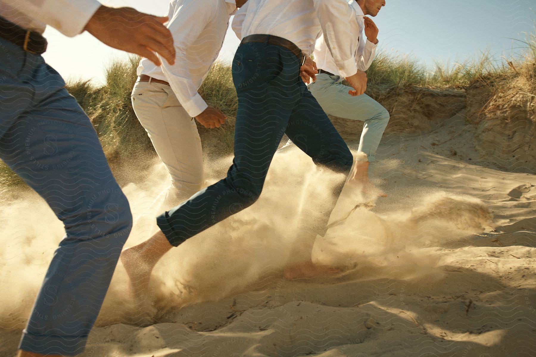 Men racing barefoot on the beach